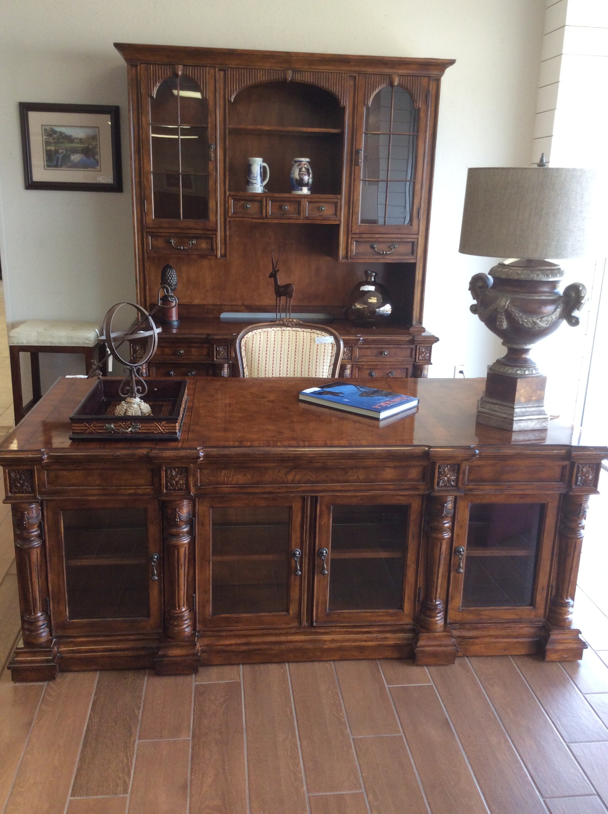 This stately desk and credenza has carved details in a dark walnut finish. There is front and back storage in the desk. Great for an office or study.