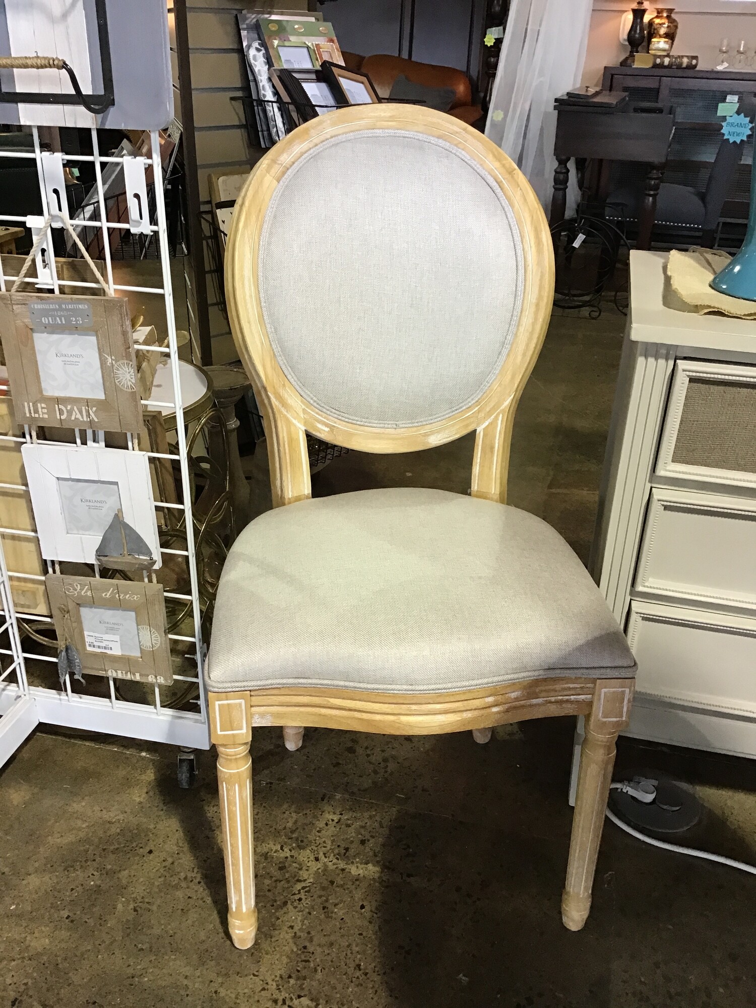 This round back upholstered chair features a driftwood frame and gray upholstery.
Dimensions are 21 in x 19 in x 40 in