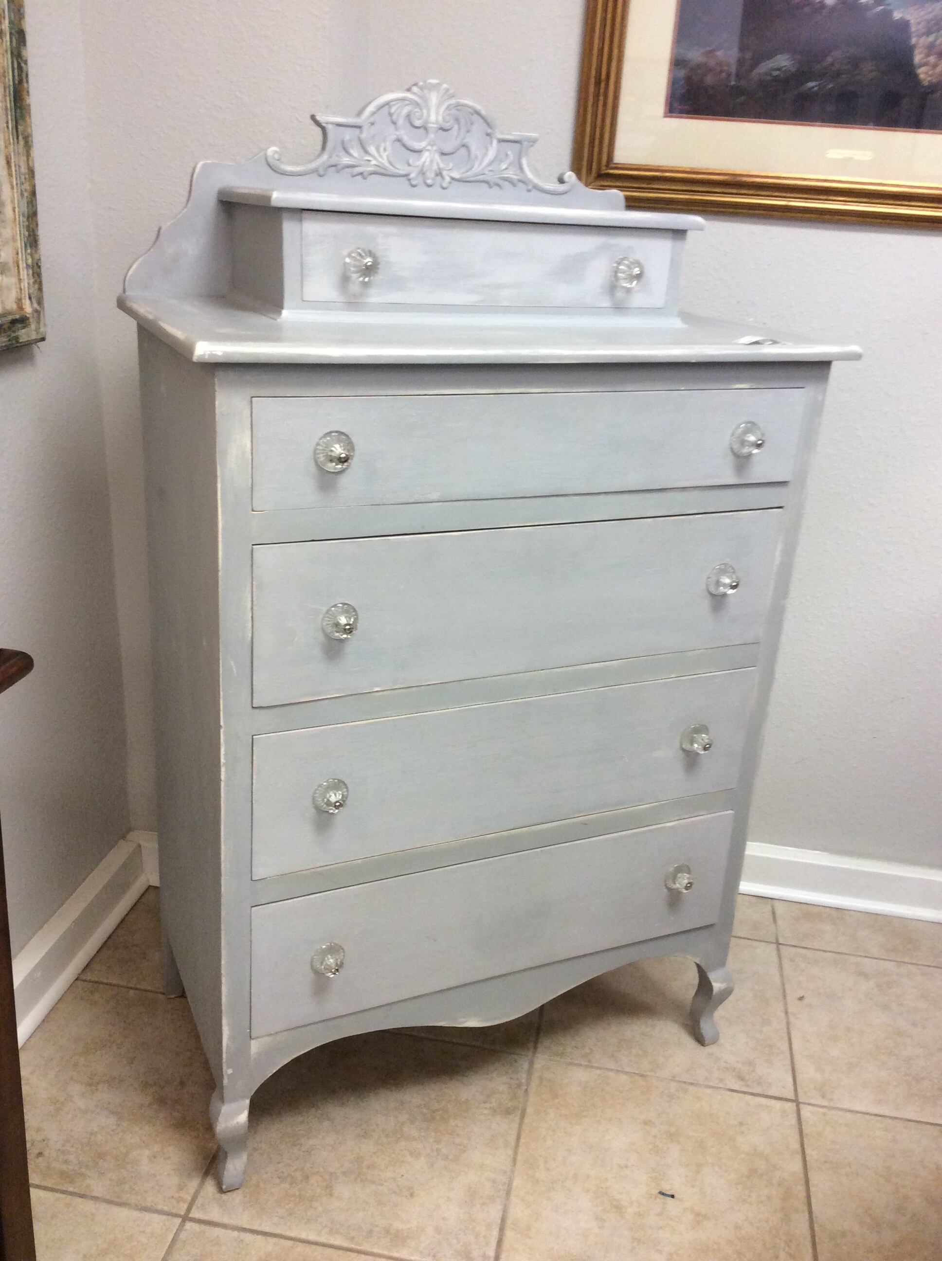 This Shabby Chic dresser has a grey chalk paint finish and glass pulls.