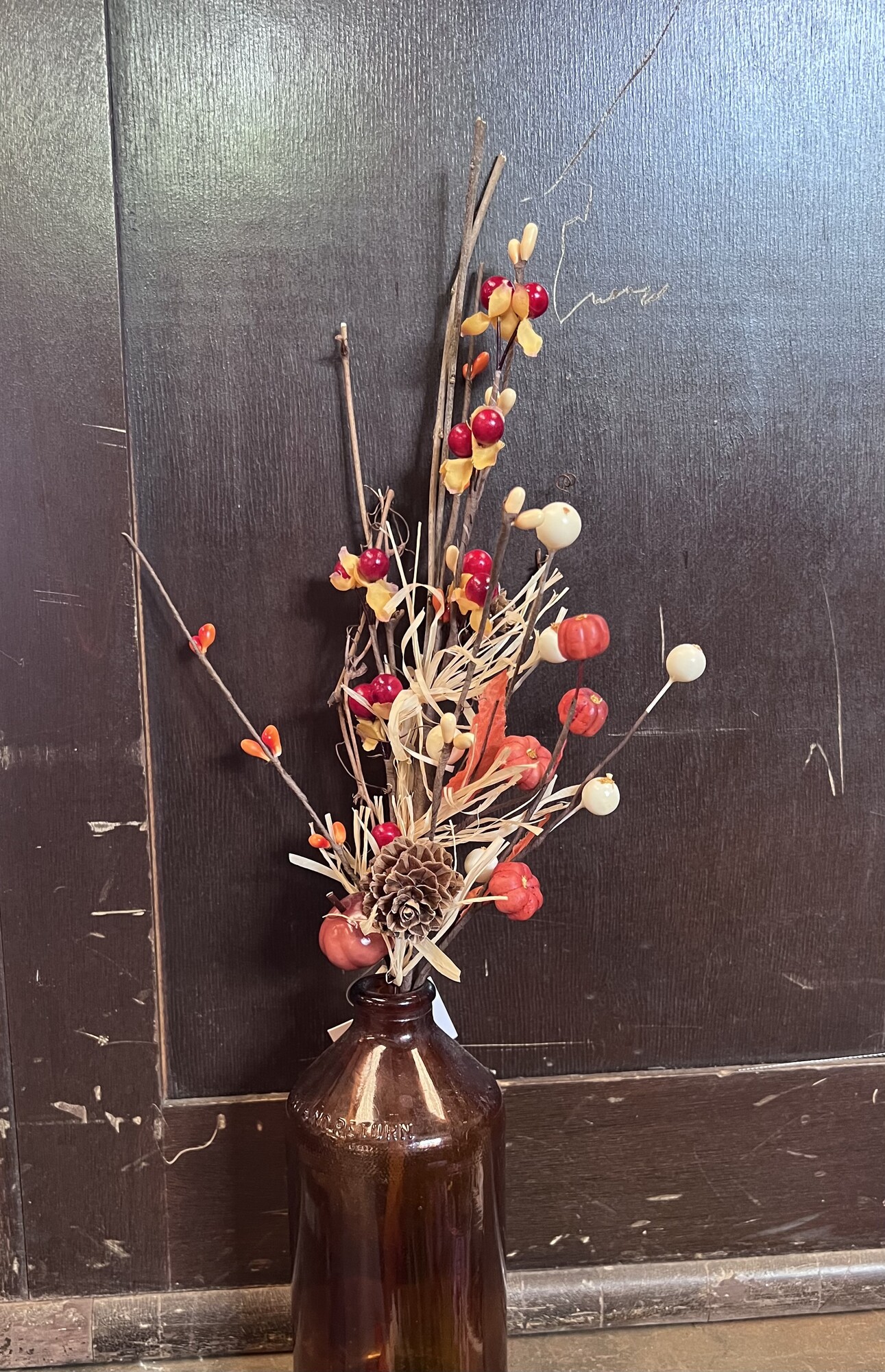 Harvest Farmfield Stem features a mix of ivory berries;  autumn colored pips; bittersweet; foam pumpkins; pine cones; orange fabric leaves and dried hay. Simply place in any vase; pitcher or can for an easy fall display that looks great all season.  Stem measures 14 inches high