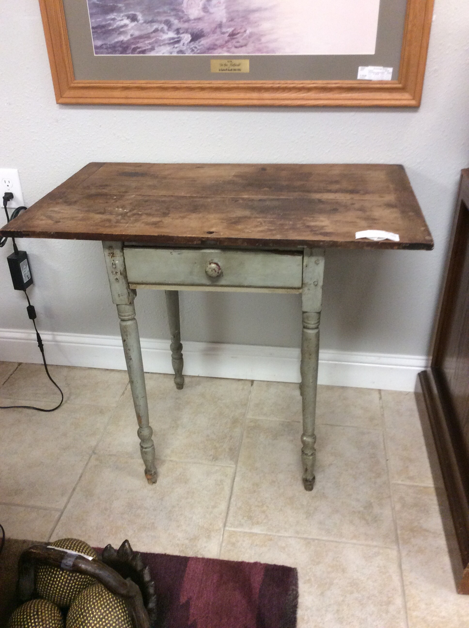 This charming rustic antique table has a center drawer and distressed painted base. Could be used in multiple settings.