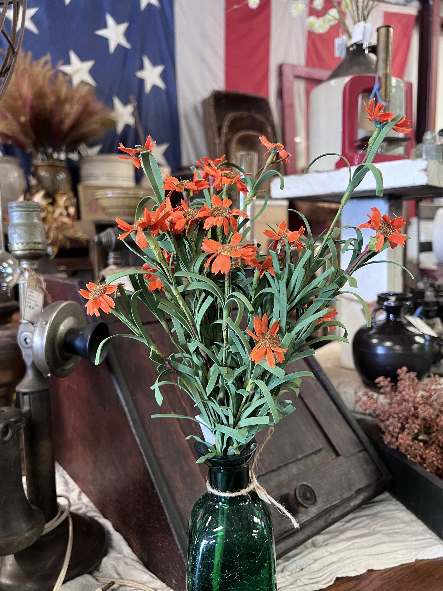 The Mini Orange Daisy Bush is a perfect touch to your fall decor.  It has pretty silk orange daisies and soft foam leaves on a brown floral stem.  This floral measures 18 inches high