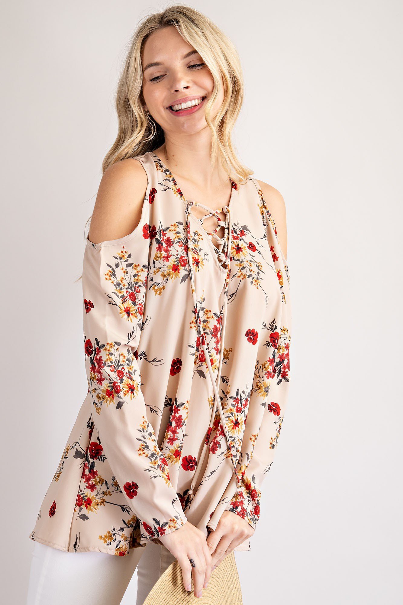 Floral Print
Woven Top
Features a Cold Shoulder
And V-Neckline with Lace-Up
Made in the U.S.A