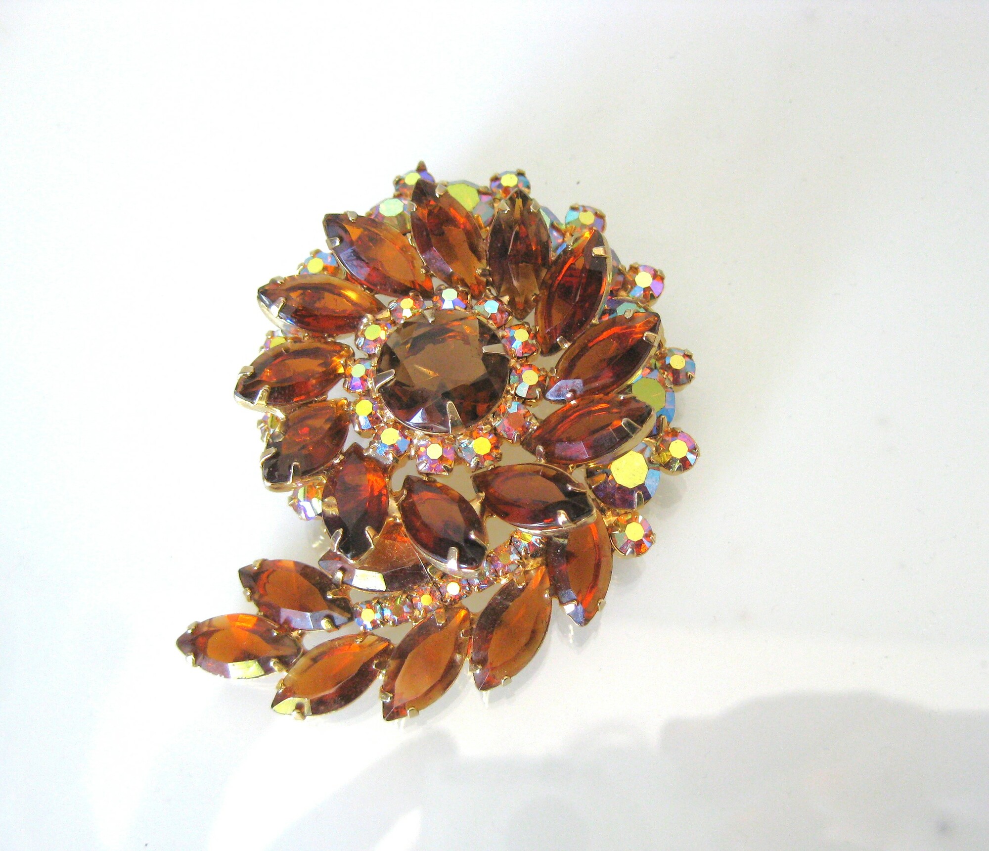 Spiral Jeweled Brooch, Amber, Size: Large

Gorgeous statement brooch of maquise jewels deep in amber/topaz interspersed with aurora borealis solitaires.
the brooch measures 3.5 across.

excellent condition!
thanks for looking!
#51055