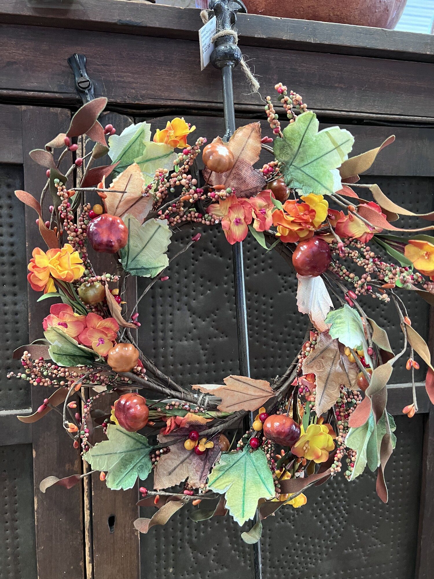 Harvest Garden Wreath is a mix of softly colored assorted fall flowers; leaves; pumpkins; berries;  spirals and pips on a wire wrapped branches. Wreath measures approximately 14 inches outside diameter