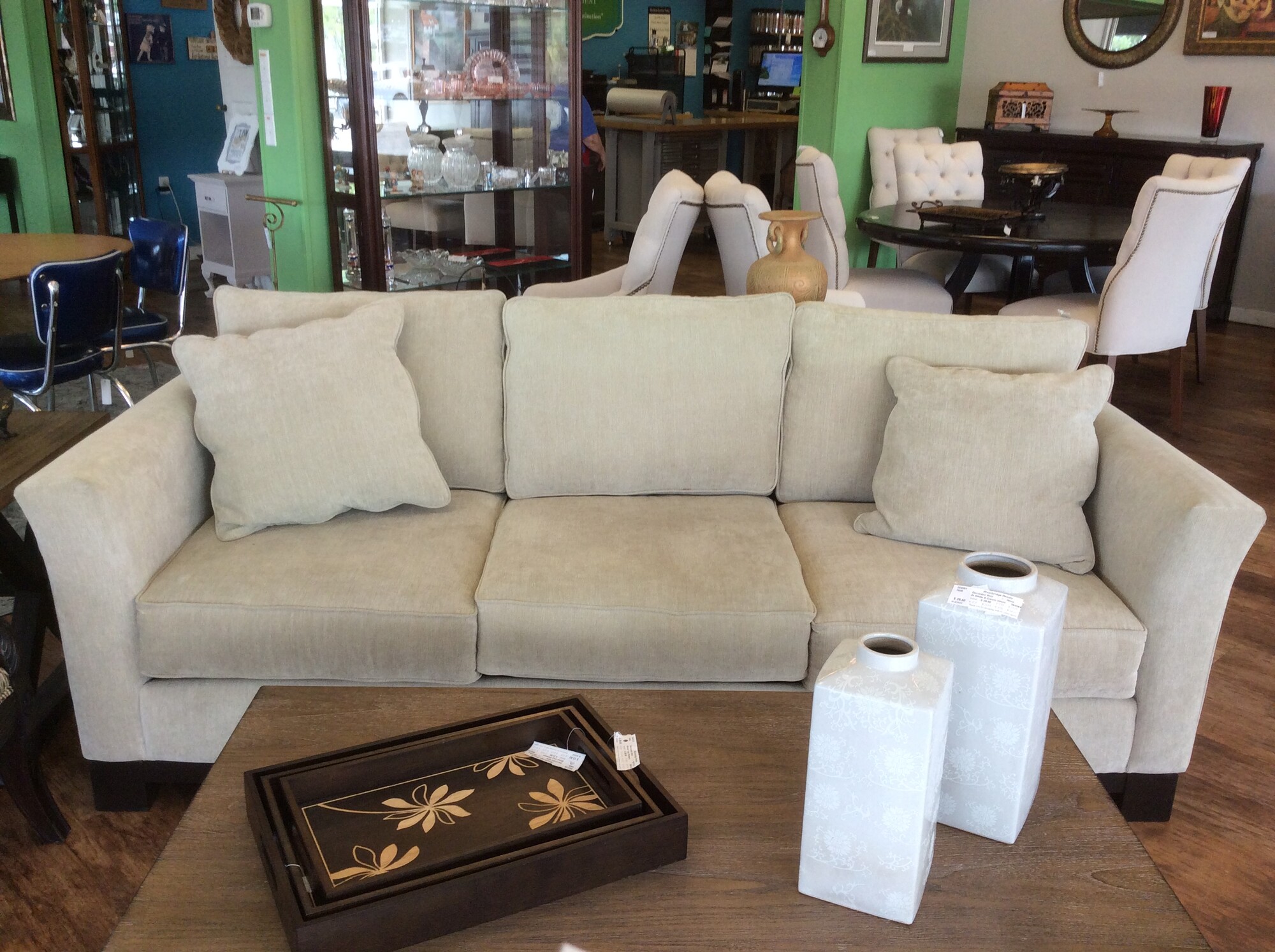 This is a cream Jonathan Lewis sofa that comes with 2 cream pillows.