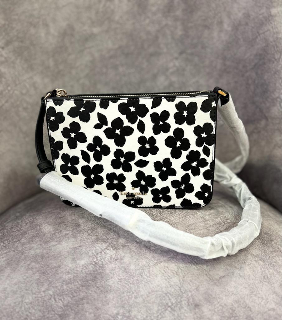 KATE SPADE
Darcy Small Slim Crossbody
DETAILS
5.5\" h x 7.8\" w x 1.5\" d
Strap drop: 22\" drop when buckled at center hole
Refined grain leather pvc
Ksny metal pinmount logo
Two way spade jacquard lining
Interior: 3 credit card slots
Exterior: 2 slip pockets on each side of crossbody
Zip closure
This bag is brand new, original paper in the ba and wrapped around straps.
no marks or flaws.
Original retail Price: $249.00