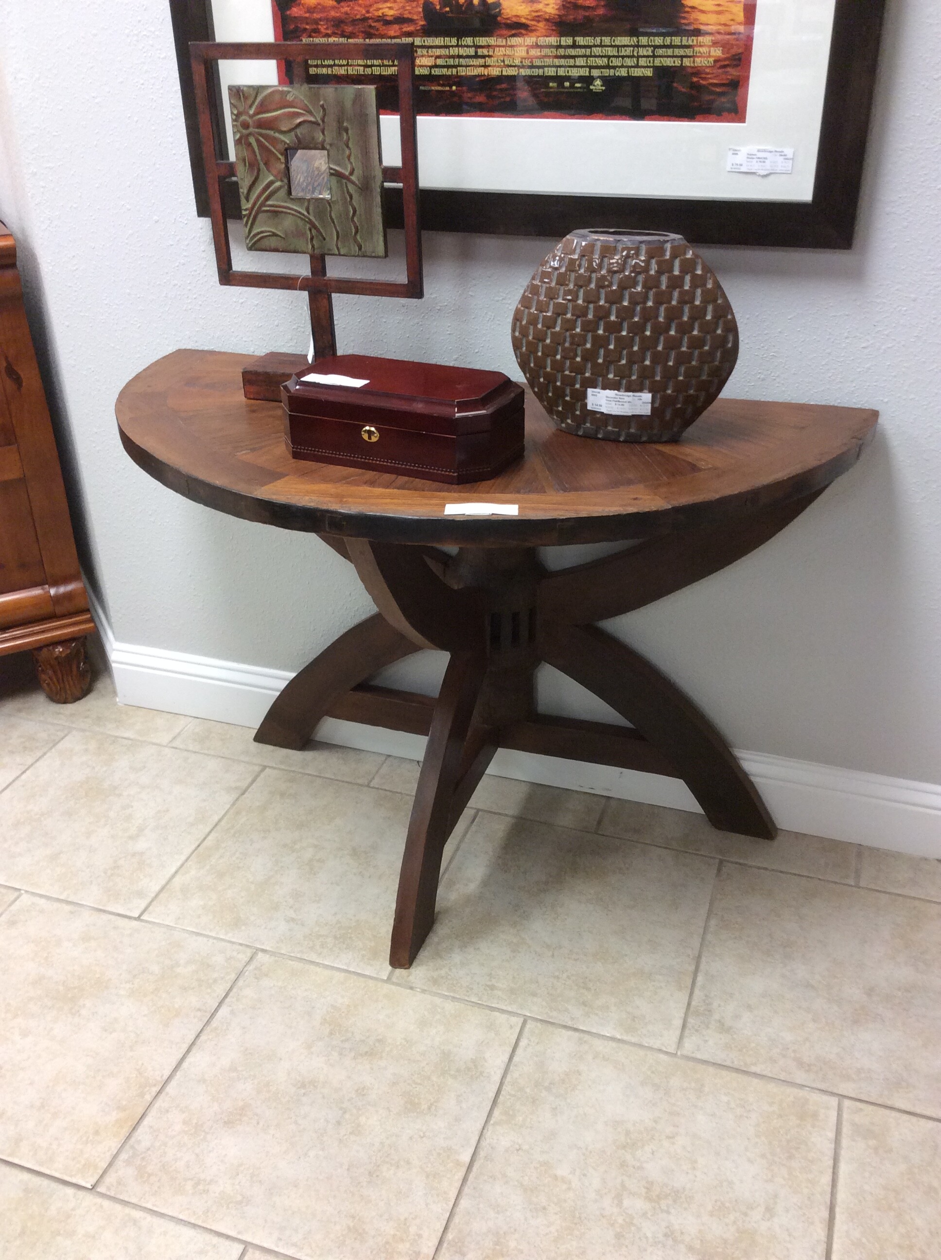 This rustic, one of a kind, semi circular table has an interesting repurposed column base in a dark wood finish. Great as an enrty table.