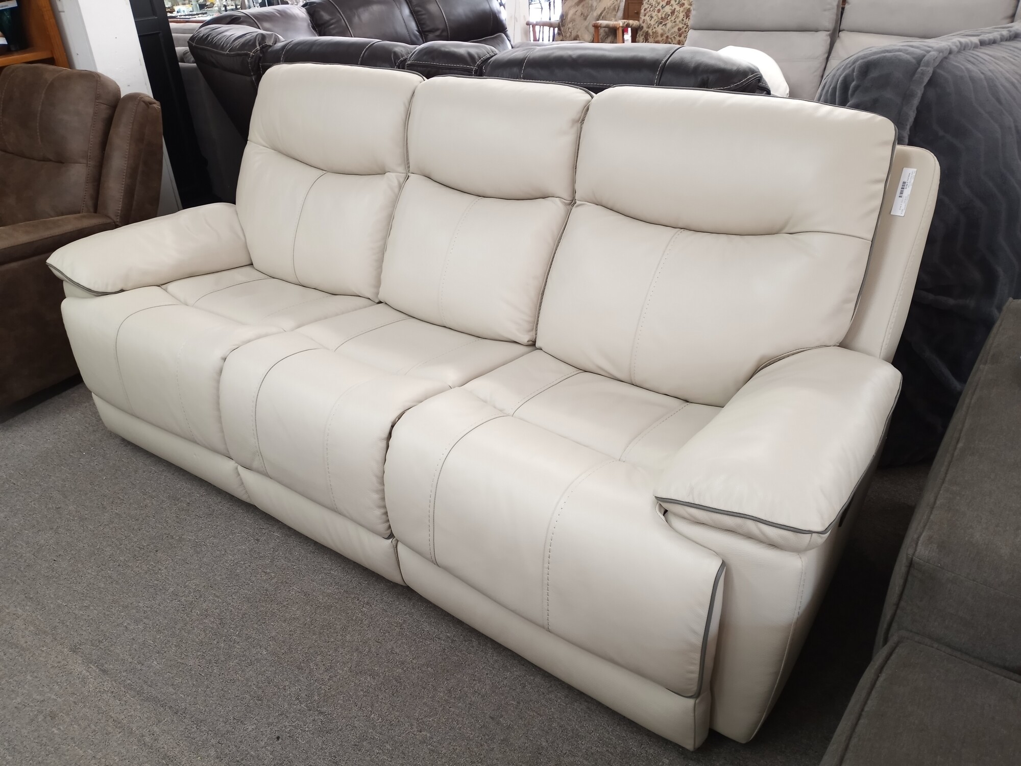 Leather Power Sofa Cream double recliner and power headrest.Features:

    Color: Cream
    Material: Top grain leather with vinyl match on sides and back
    Two USB ports
    Two power recliners with power headrests
    Leggett & Platt ® reclining mechanism
    CloudZero™ elevates legs higher, reducing back stress