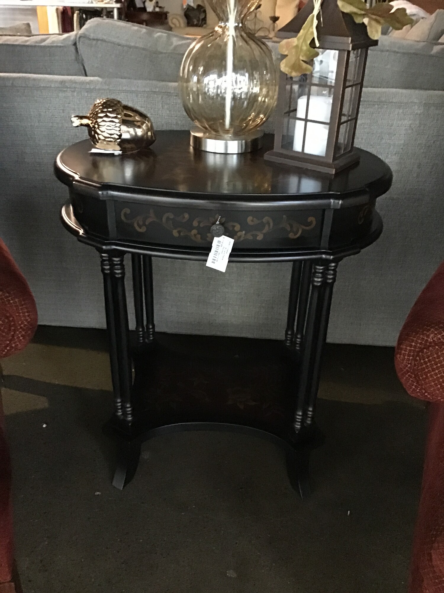 Accent Table
1 Drawer
Lower Shelf
Double rail sides
Black with light gld painted leaves, flowers and birds

Dimension: 25x17x29