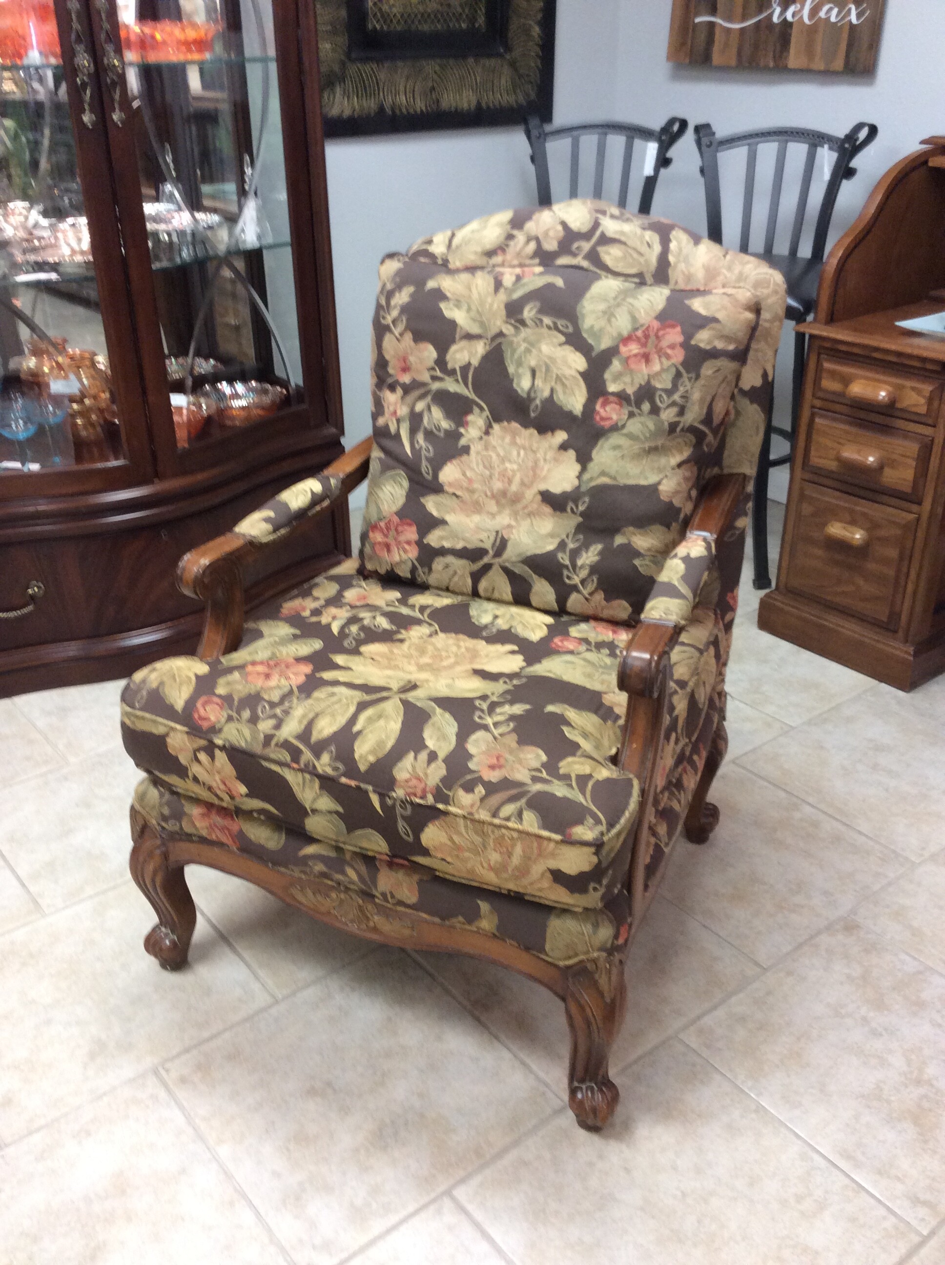 This is a floral and wood accent chair.