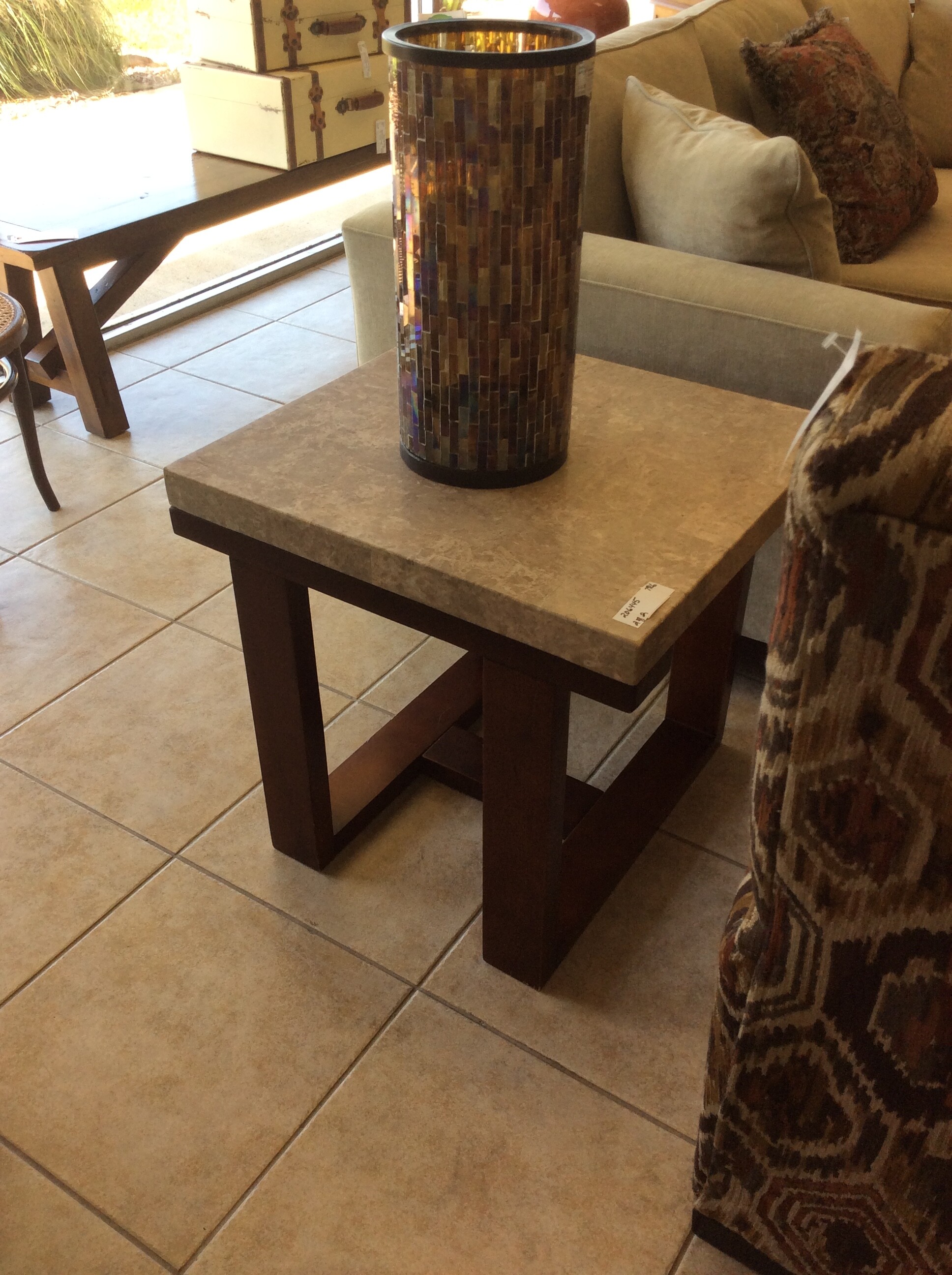 This is a pair of light marble end tables with a wood bottom.