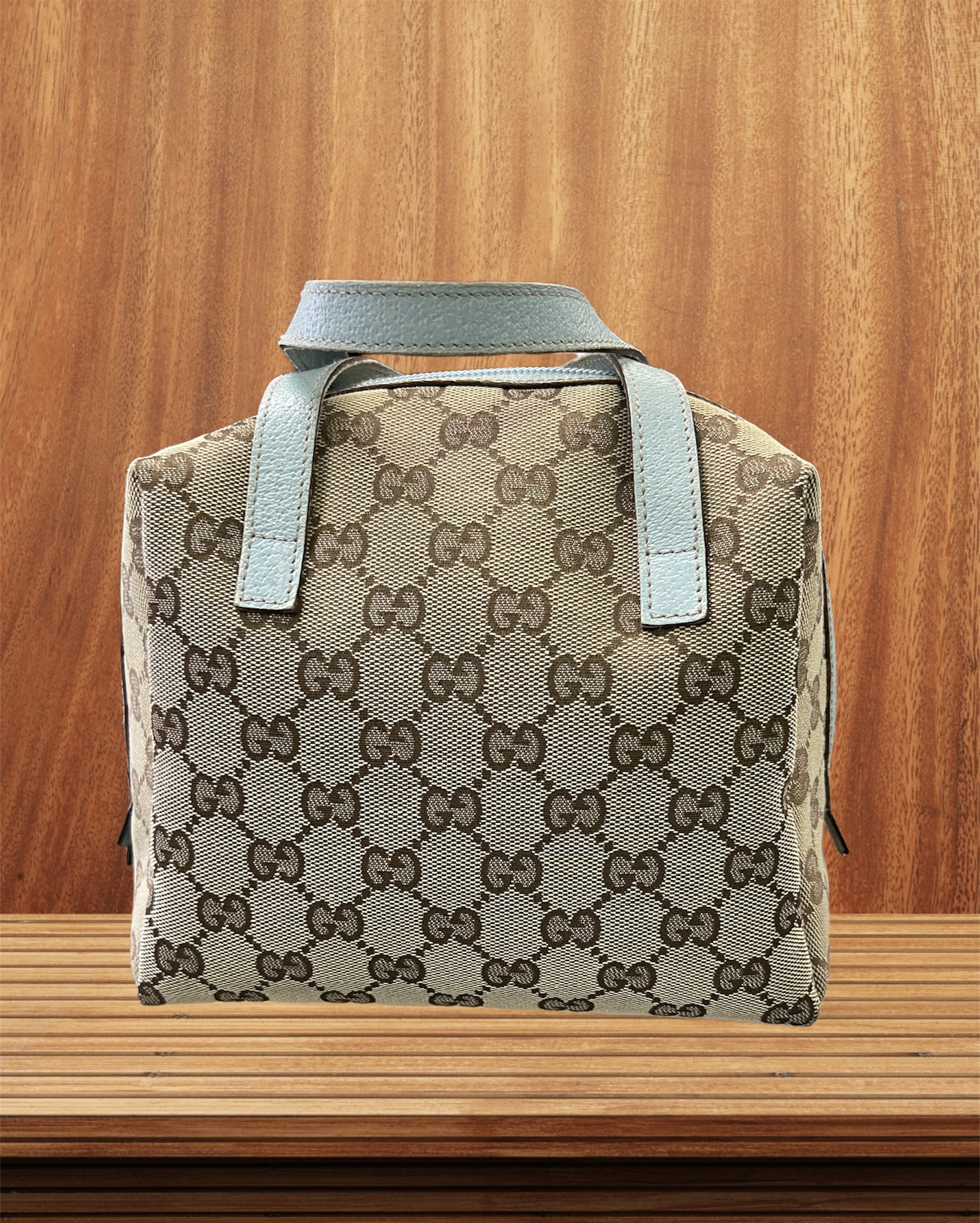 GUCCI GG Canvas MINI Zip around Bowling BAG
This bag is VINTAGE
Serial Number 124542-0416
Size:
Length: 7.50 in
Width: 4.00 in
Height: 7.50 in
Drop: 2.75 in
This is an authentic GUCCI Monogram Mini bag in Sky Blue. This stylish mini satchel is crafted of beige Gucci GG monogram canvas. The bag features sky blue leather top handles and trim with a wrap around zipper. This opens to a black fabric interior. This is a superb tiny tote for everyday essentials from Gucci!
Great Buy for someone starting to branch out to GUCCI or add a fun Vintage piece to their collection.
Overall in good condition.  Signs of wear on the handles.  Canvas and Interior in great condition.
Most sites are selling this bag easlily over $500.00
Adorable!