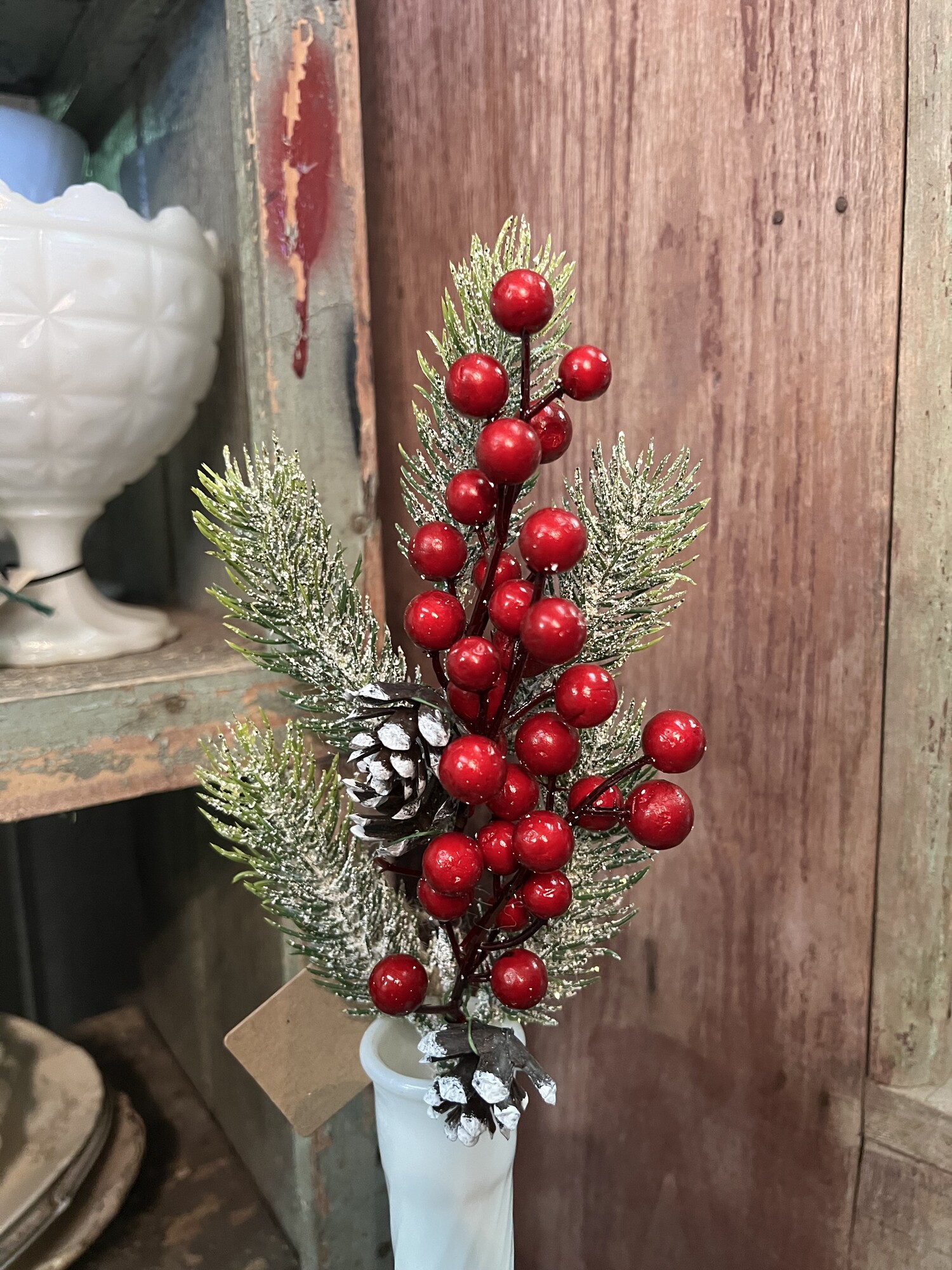 The Berry And Pine Stem measures 17 inches high.
Its mixture of berries, pinecones and snowy greenery with just a touch of gliter make this a perfect stem to just drop in any vase