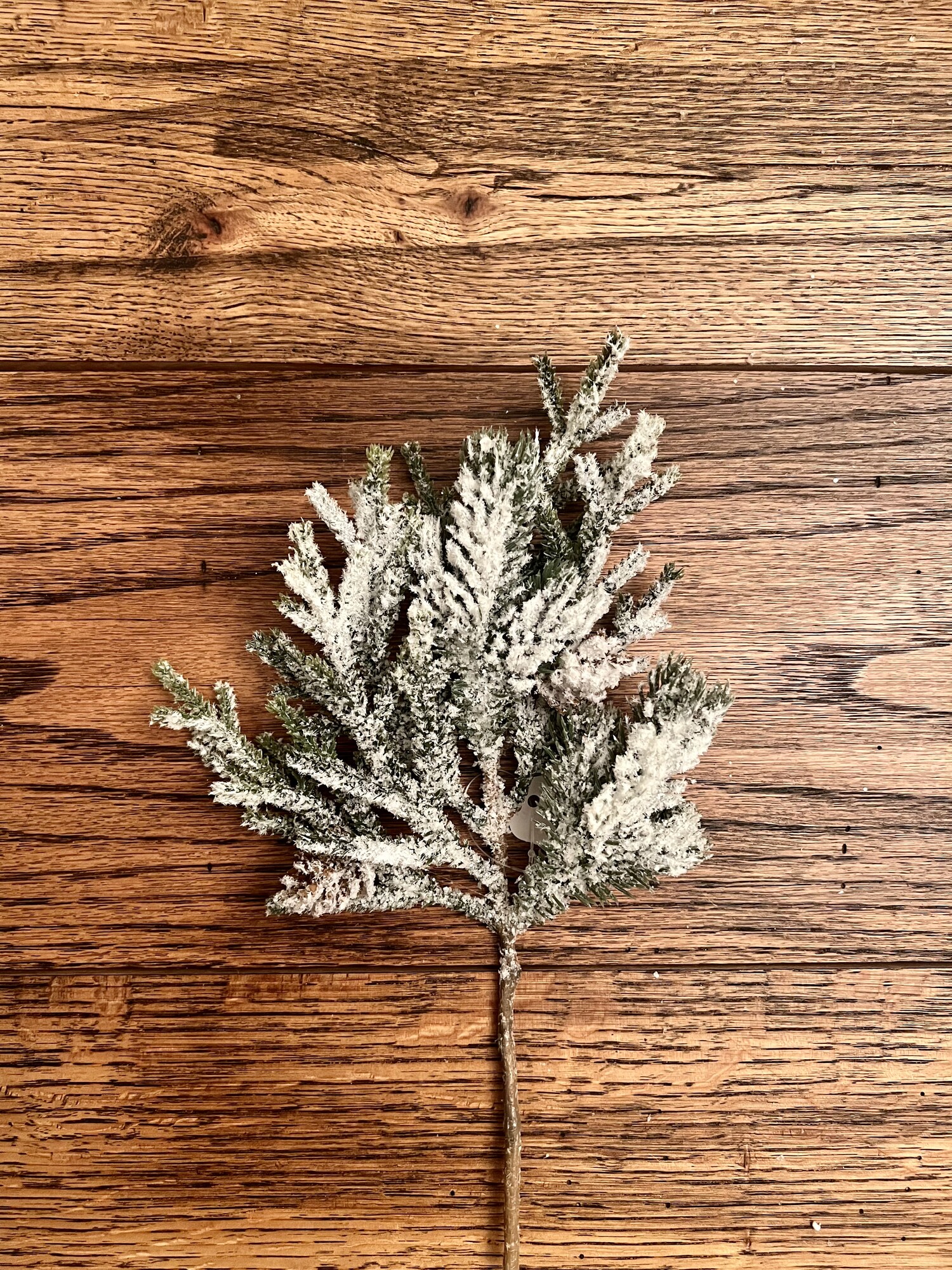 The Snow Pine pick is heavily snowed with small pine cones, a touch of glitter and is the perfect small stem to add warmth to the winter season anywhere in your home. Pick measures 11 inches tall and 6 inches wide