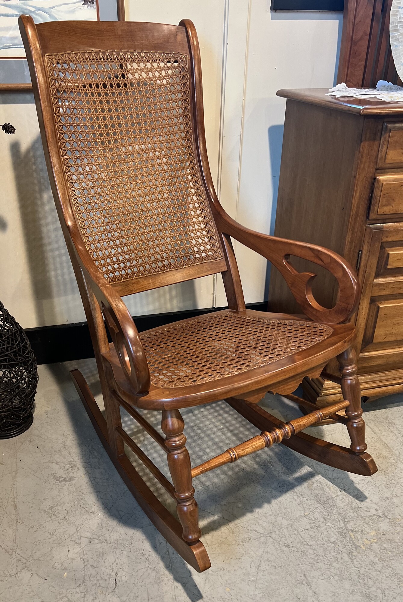 Amana cain wood rocker.

Beautifully carved medium wood Amana rocker chair with a wicker cain seat and and back rest.

Comes with Amana furntiure polish.

There is minor wear on the wood.

41in tall x 22in wide x 32in deep x 18in tall (seat to floor)