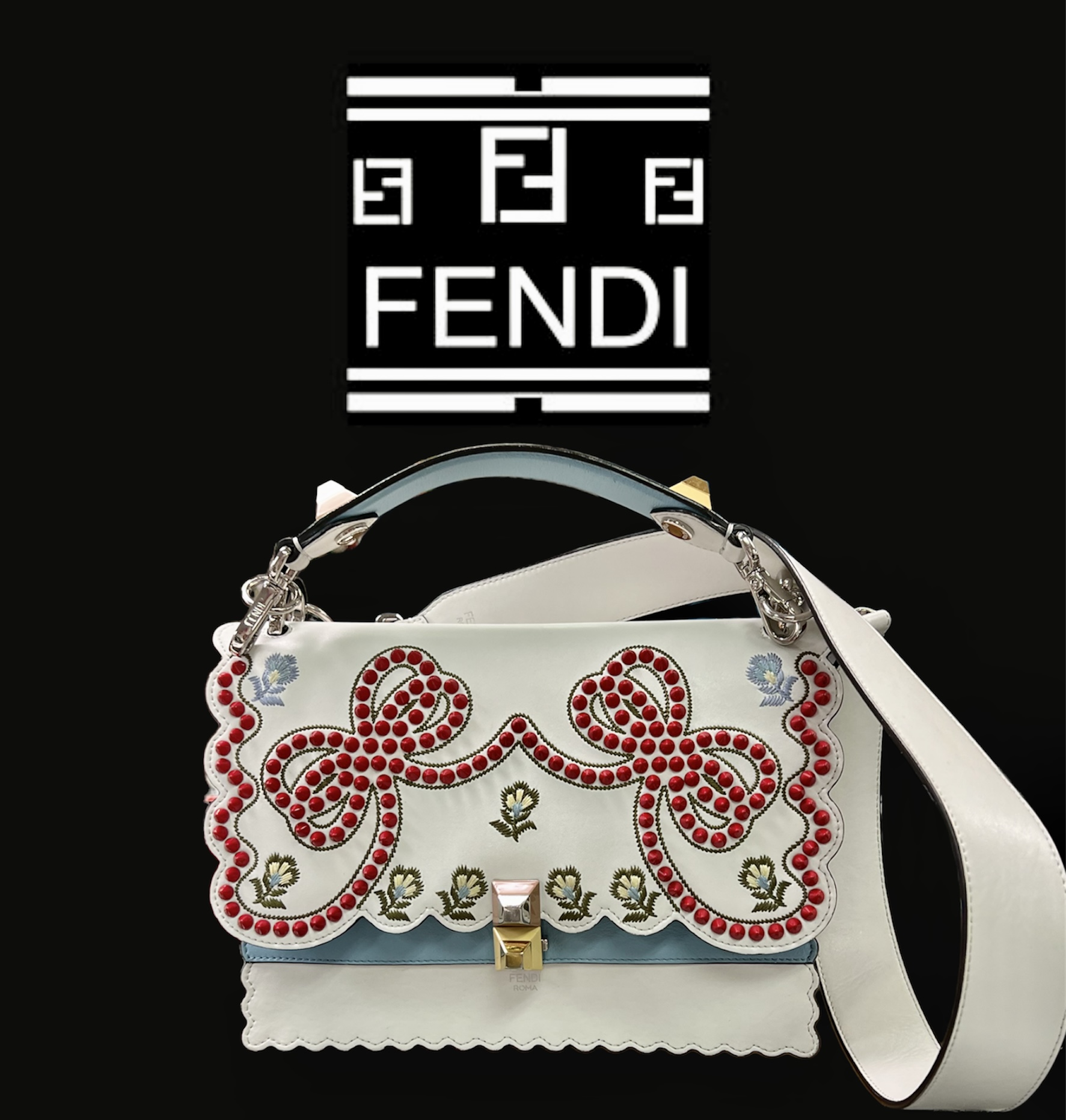 Fendi Kan I Handbag Embroidered Studded Leather Medium Handbag
This authentic Fendi Kan I Handbag Embroidered Studded Leather Medium is a uniquely designed bag perfect for the stylish fashionista. Crafted from white leather, this bag features contrasting studs in the characteristic bow design, embroidered flower details, leather top handle, detachable leather strap, double stud two-tone plexiglass twist-lock closure and silver and gold-tone hardware accents. Its twist-lock closure opens to an off white microfiber-lined interior divided into two compartments and with a slip pocket perfect for storing your bare essential. Its detachable strap allows this bag to be worn longer on the body for added versatility.
******Estimated Retail Price: $3,550*******
Condition: Very good. A-/B+ Wear consistent with age and use.  Slight curling on front, creasing on sides, minor wear underneath flap, and in interior. Minimal scratches on hardware.
Accessories: detachable strap and handle.
Measurements: Handle Drop 5\", Height 7.5\", Width 10\", Depth 5\", Strap Drop 18\"
Designer: Fendi
Model: Kan I Handbag Embroidered Studded Leather Medium
COMES WITH CERTIFICATE OF AUTHENTICITY