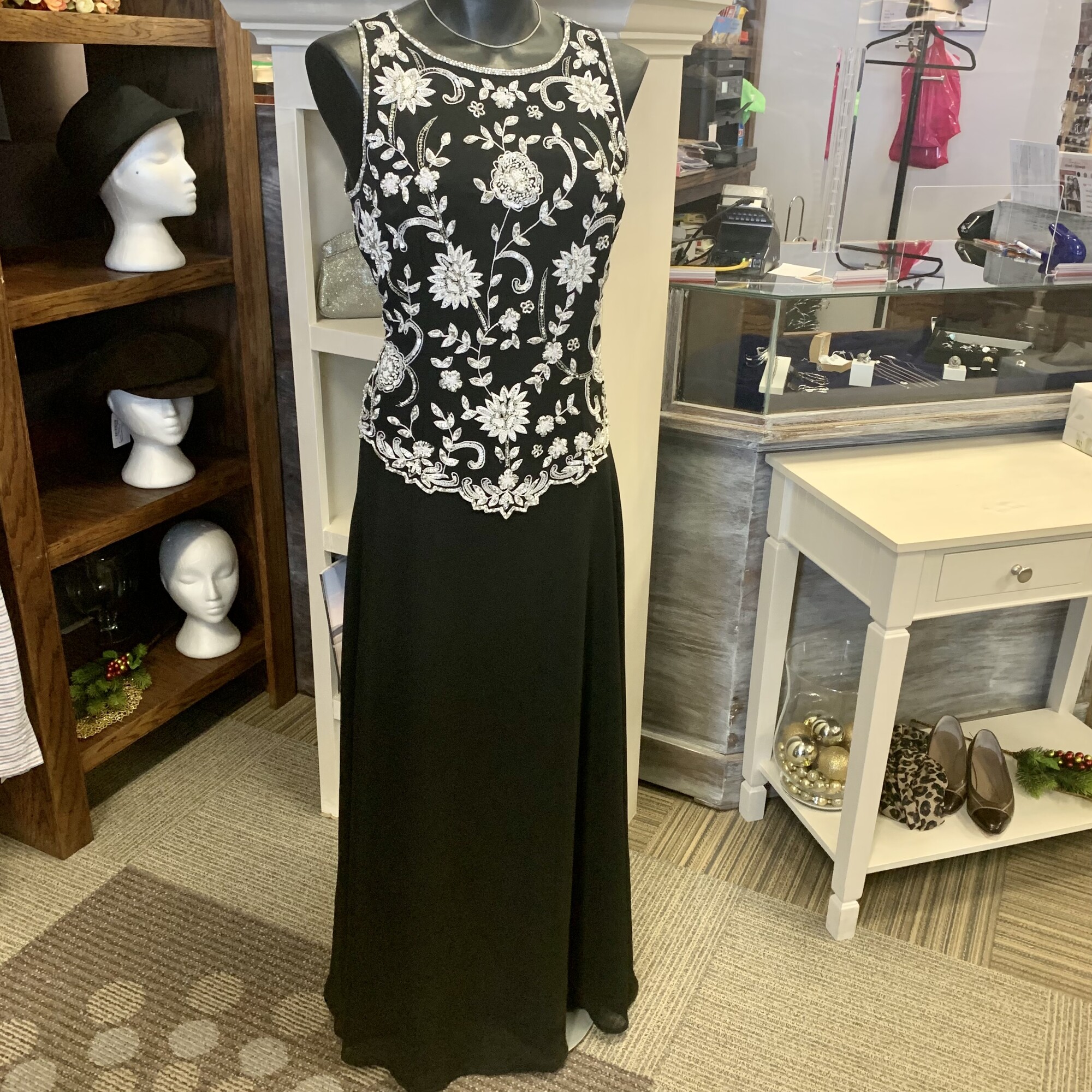 Dkara New York Gown,
Colour: Black with silver and white beading,
Size: 10; armpit to armpit: 19inch
Beautiful dress with semi detached top ensuring an elegant waistline.