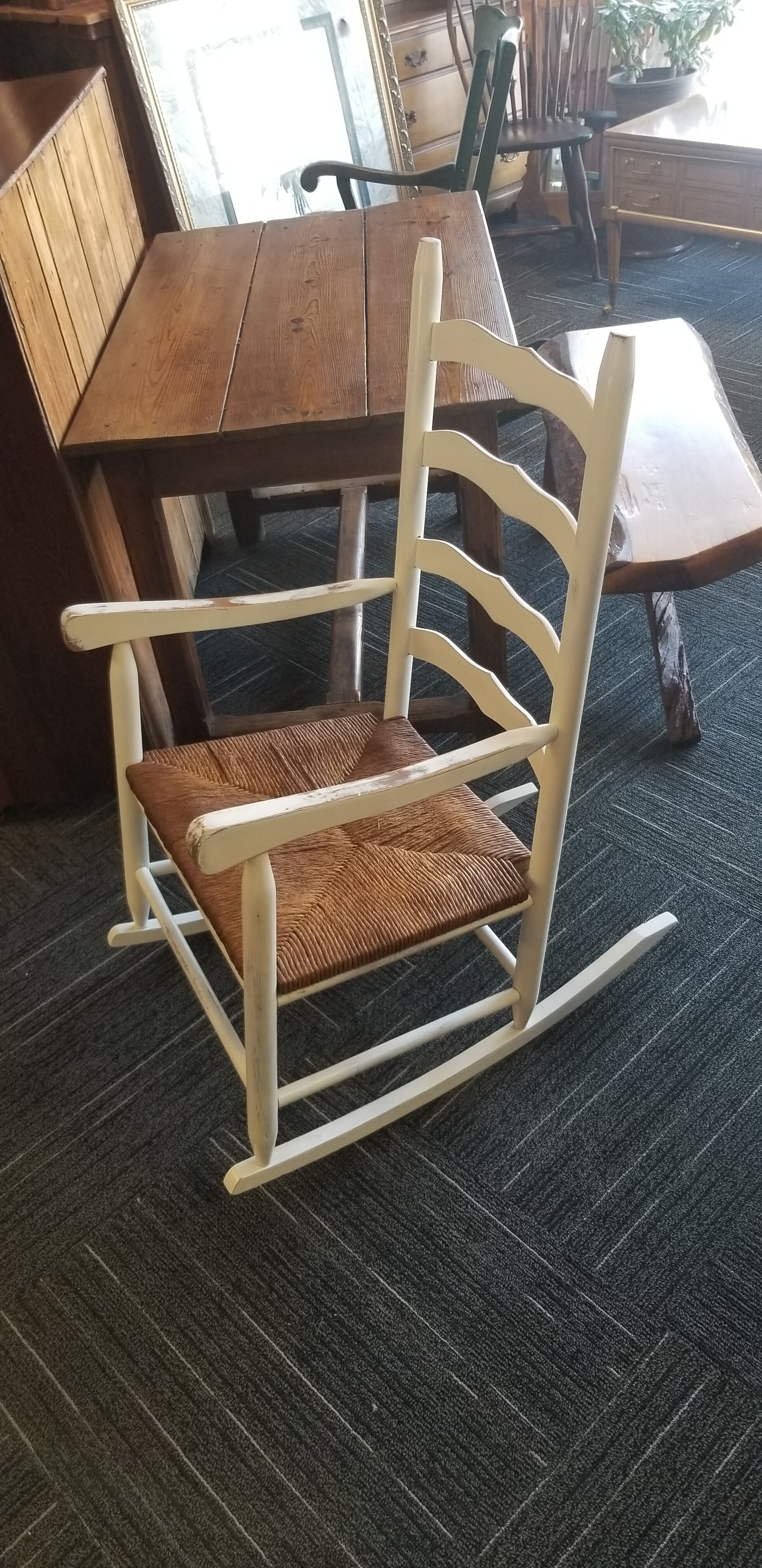Antique rocker with rush seat. 22in wide.