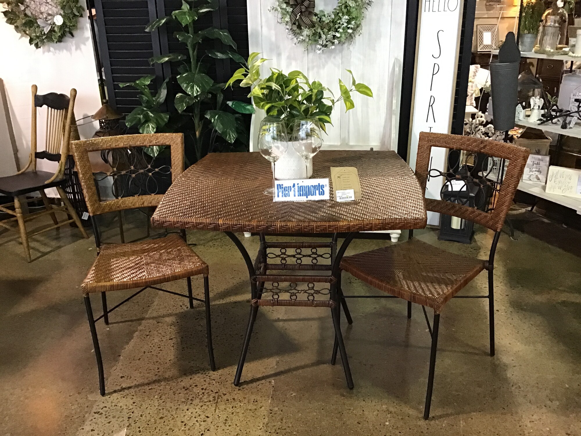 Pier 1
Rattan top Table w/ black metal legs
2 Chairs w/rattan seats and backs with black metal detailing and legs

Dimensions 35x35x30, Size: Pier1