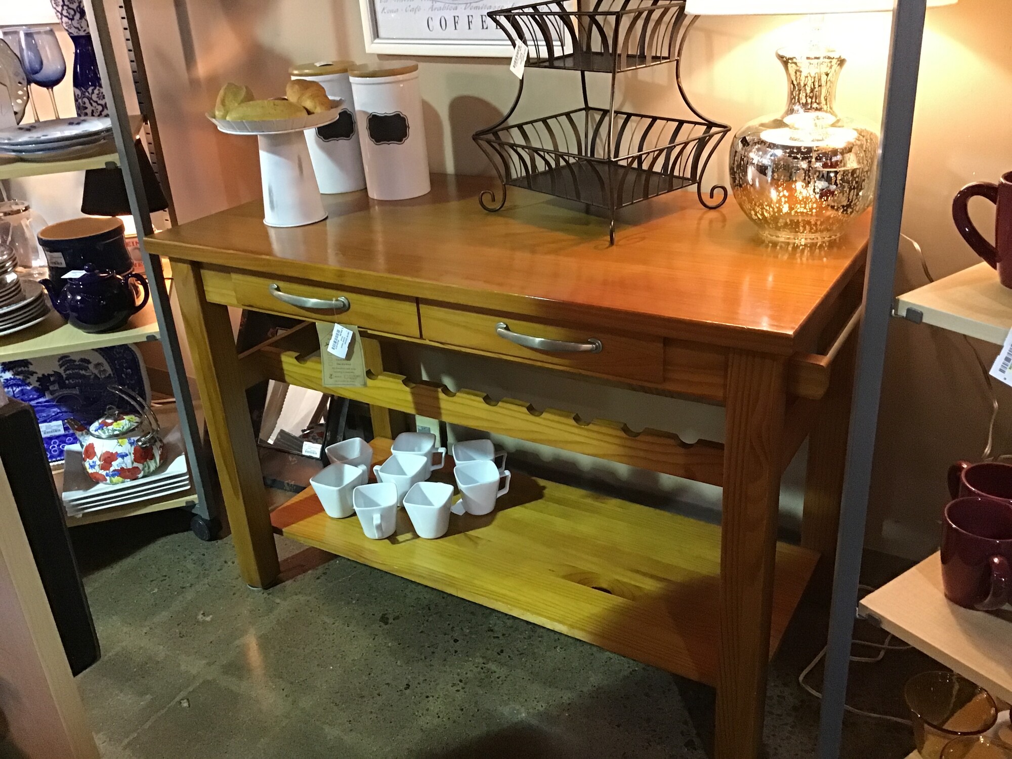 Center Island
Finished on all four sides
Long drawer with double silver pulls
Holds 10 wine bottles
Long lower shelf
Towel bar on side
Four sturdy straight legs

Dimensions: 48x24x32.5