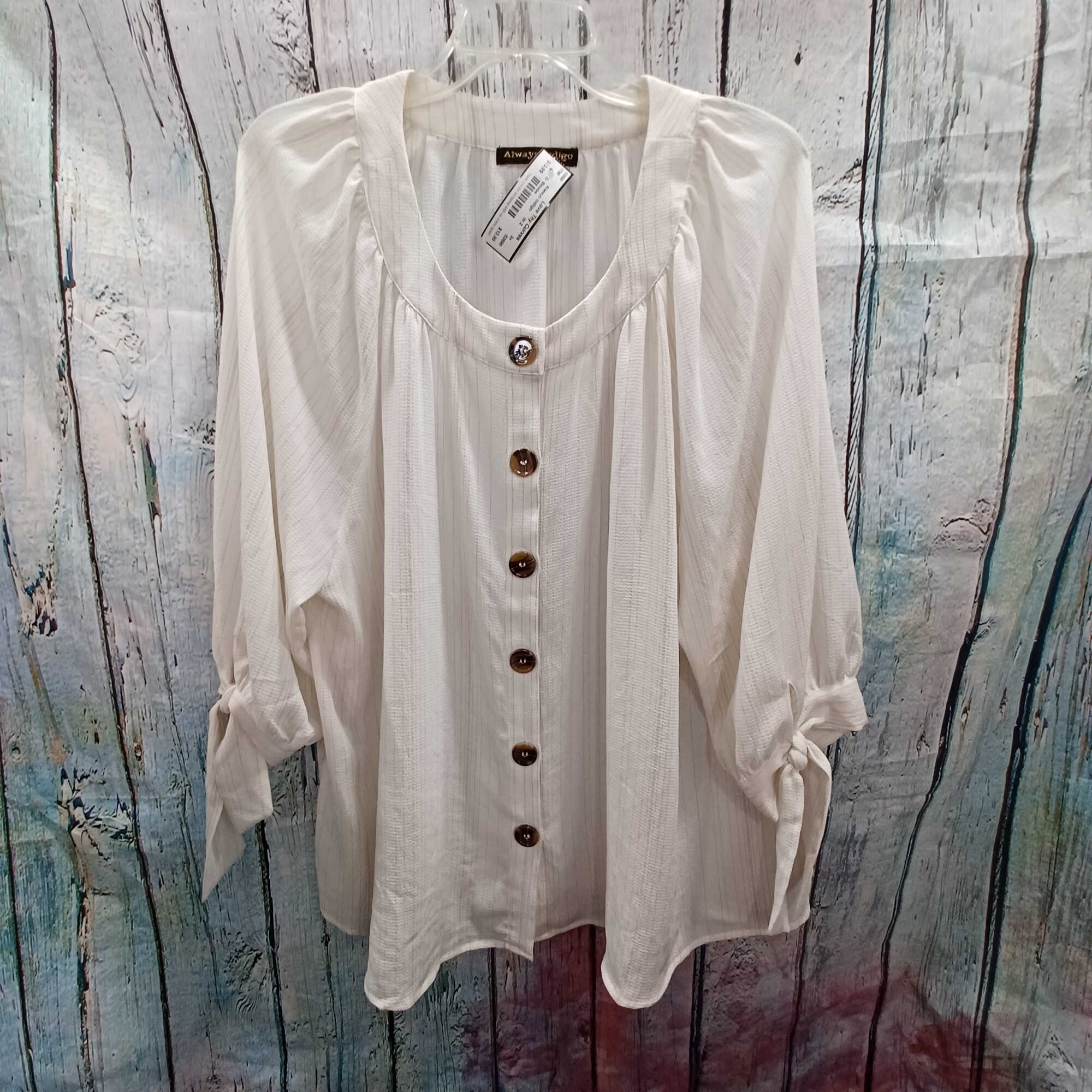 Great lightweight blouse  that is perfect for the office or even paired with your favorite jeans for a put together girl on the go look. White, gold metallic threading in vertical stripes and half sleeves