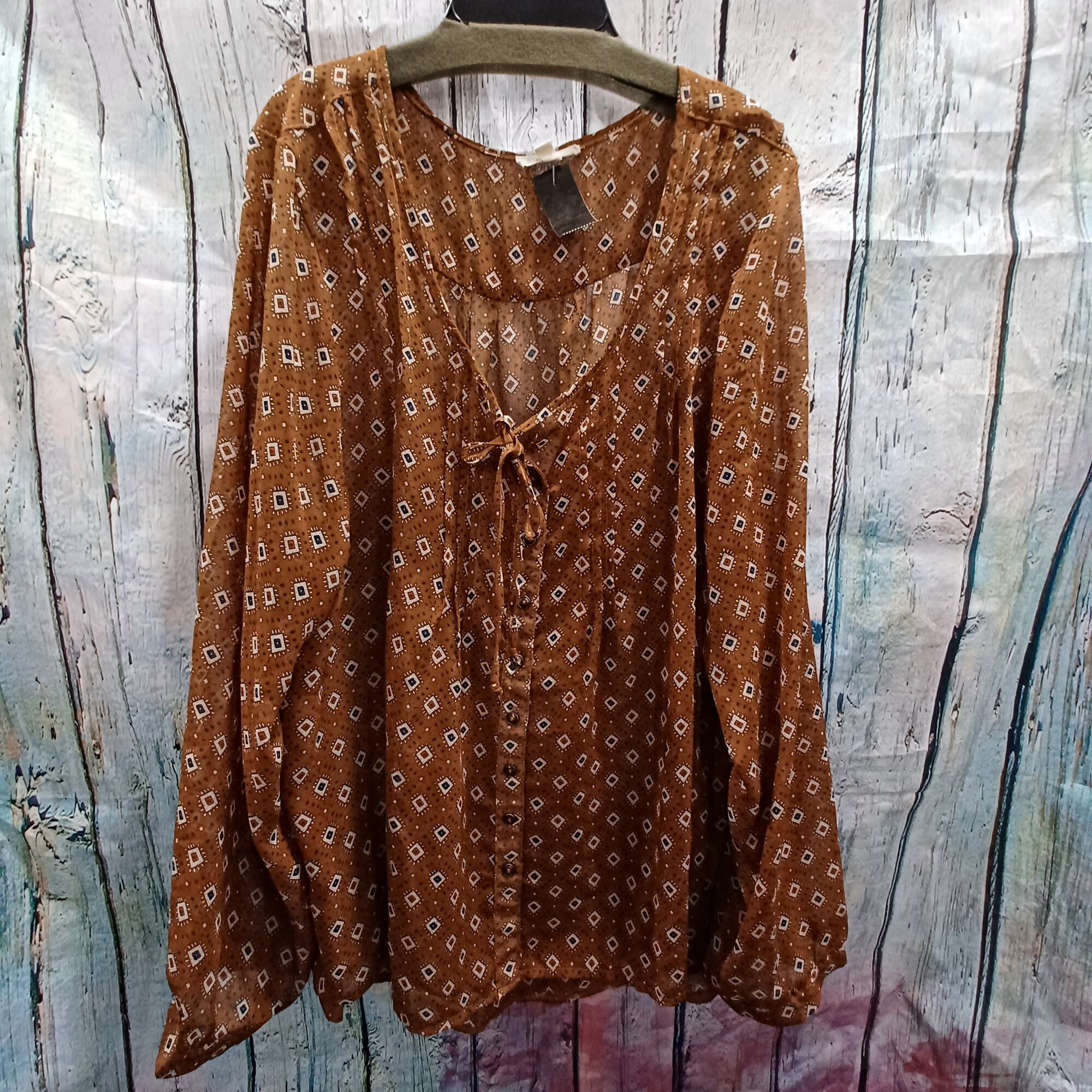 Semi sheer button up blouse with long sleeves in brown with funky white, red and blue pattern