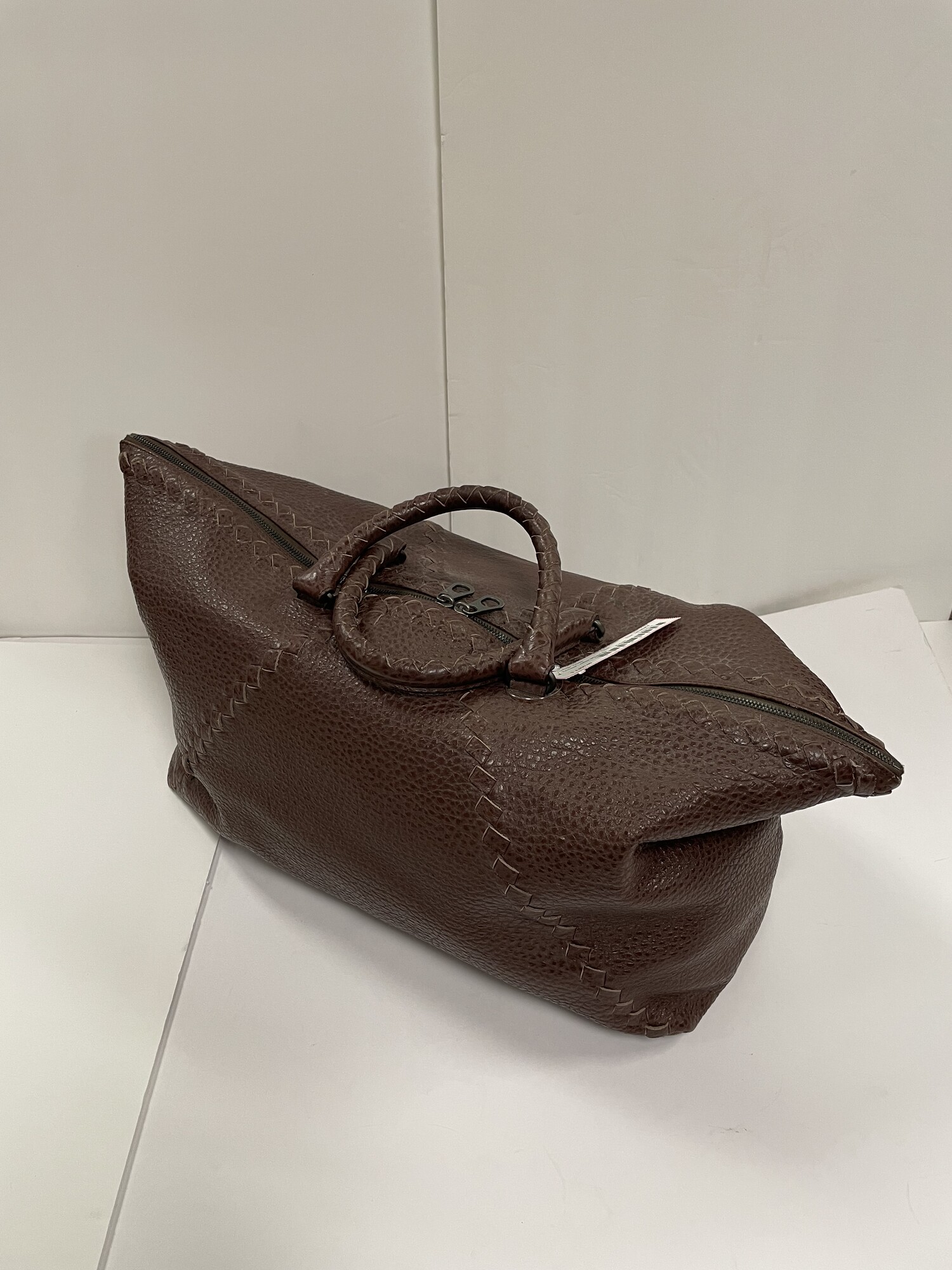 Bottega Veneta:  Textured Leather Weekend Bag, Chocolate, Size: 24 x 18 x 8.5 inches. Not to be fooled by its  Masculine look, this bag would made a beautiful addition to the travel styles of anyone.