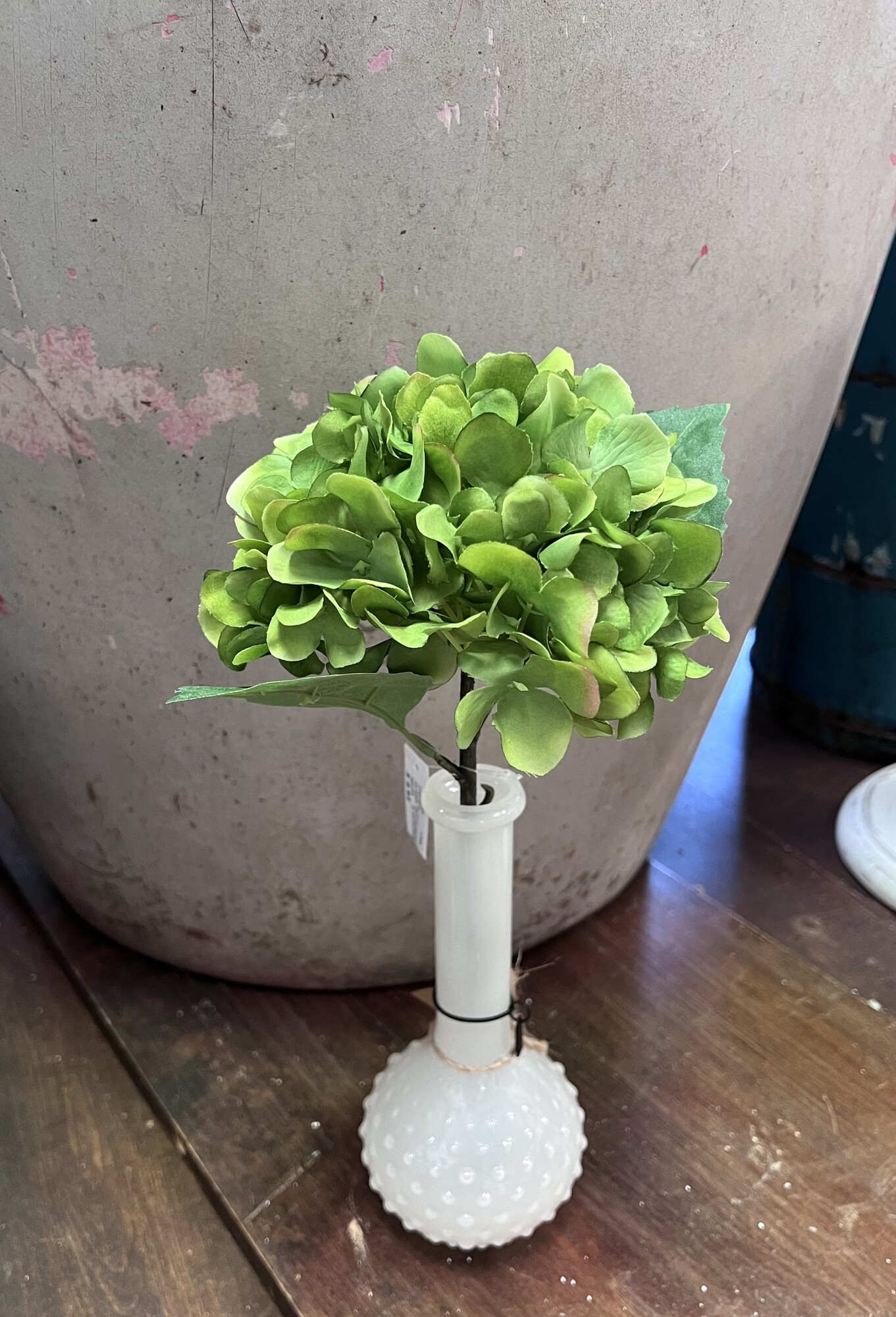 We are in love with the shade of this pretty green hydrangea. This stem has fabric petals and leaves with a plastic stem.  Hydrangea measures 13 inches tall and looks beautiful alone in any vase or grouped with any  floral arrangement