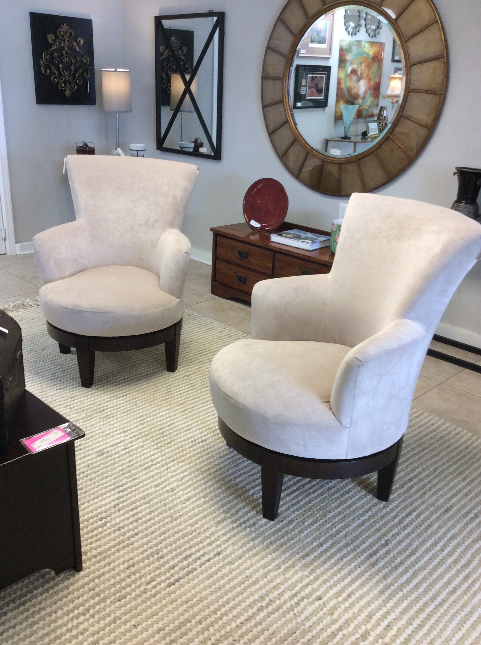 This is a very nice pair of cream suade, swivel barrel chairs.