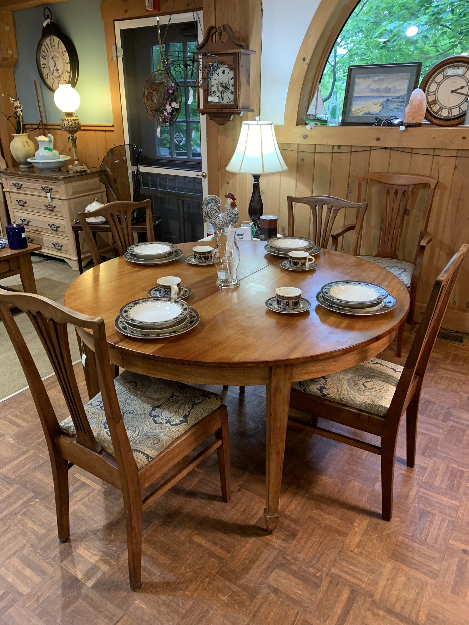 Oak Table W/5 Chrs & Leaf
54 in Round 29 in High 10 1/2 in Leaf
Beautiful Oak table made by the Conant Ball Co in Boston.  There are 5 upholstered chairs - one of them is an arm chair.  It is in wonderful conditon; a true heirloom. Ther is one leaf which extends the table by 10 1/2 inches make it 64 1/2 inches wide.