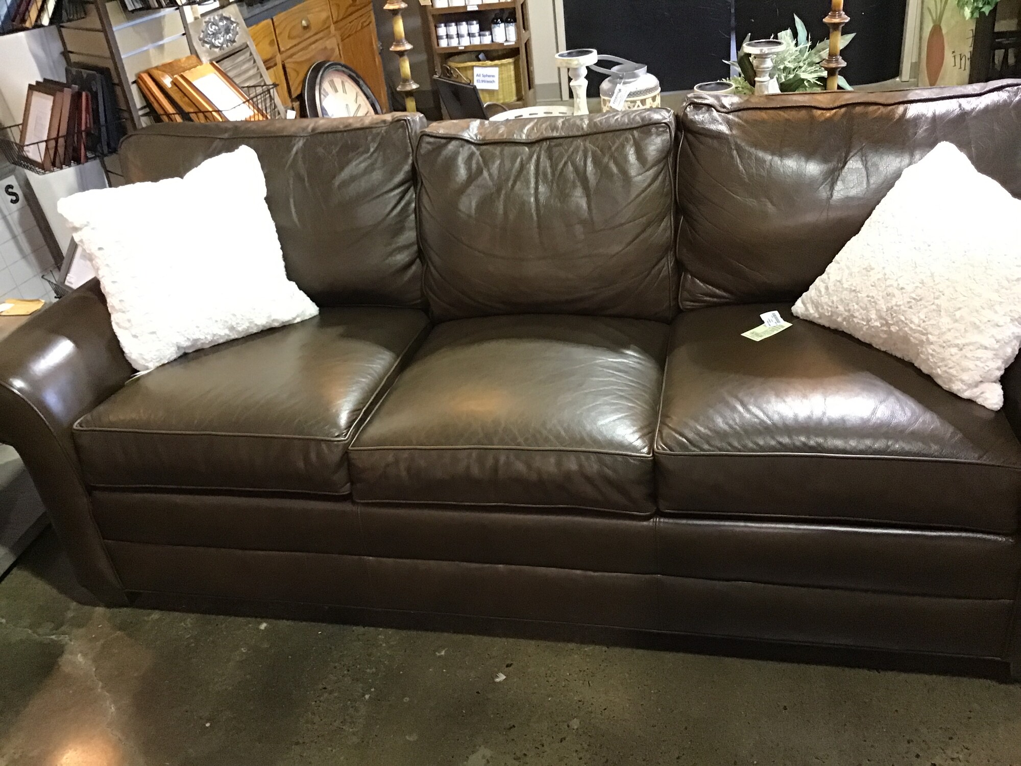This Ethan Allen Bennett leather three-seat sofa has classic design written all over it.  Featuring luxurious leather, opulent rolled arms and welted loose cushions

Tailored by hand over a durable engineered wood frame.

Poly-wrapped high-quality foam and fiber cushions for a supportive seat.

Removable, tapered legs shown in Raisin, a rich, cool, dark brown water-based finish.

This sofa is priced $50 less than the matching sofa due to a small mark on the leather

Matches # 170099

Dimensions:  87 x 37 x 36