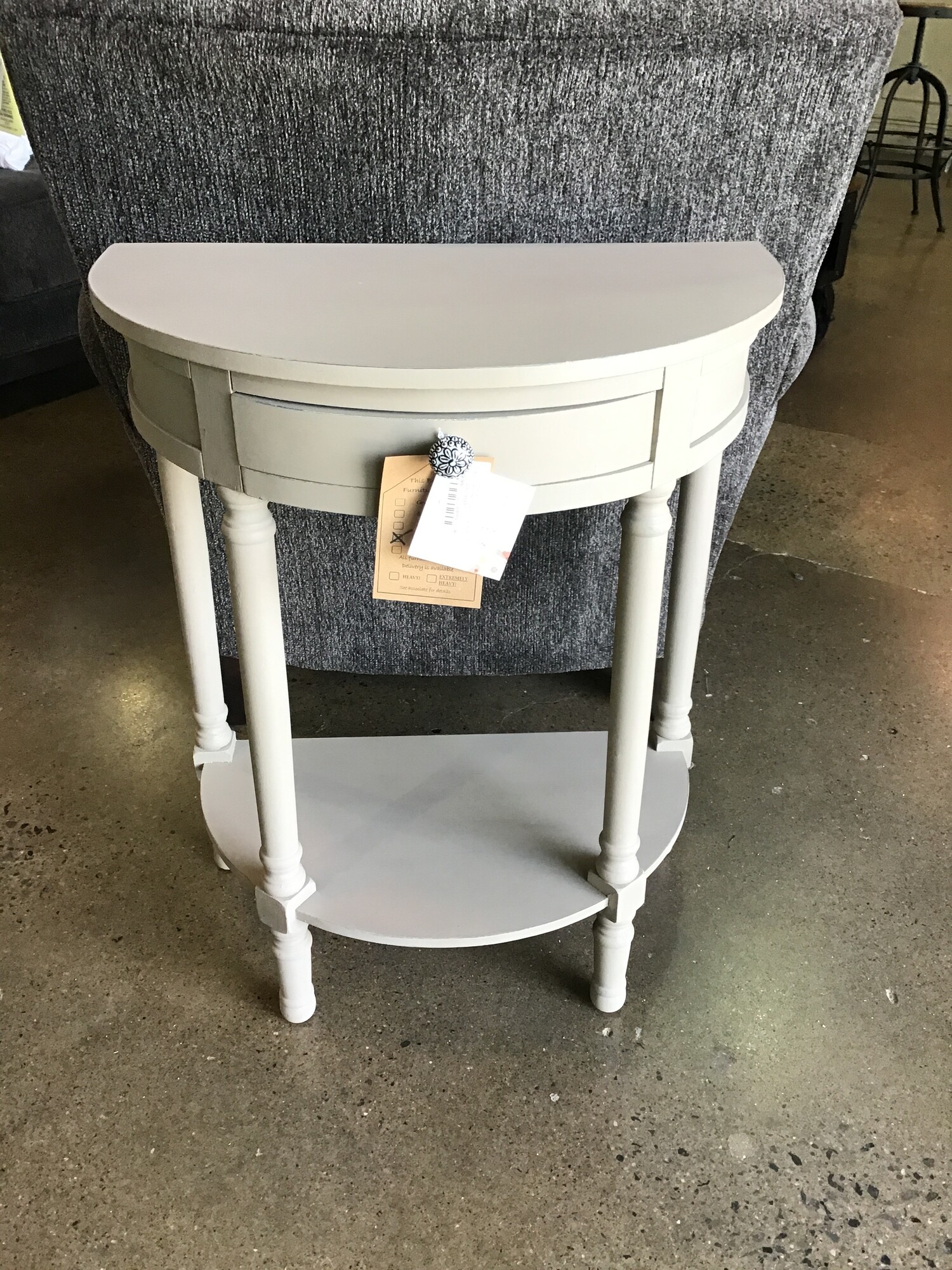 This beautifully updated demilune table was painted by one of our local artists using Country Chic Driftwood paint and clear wax. It features a small drawer, funky knob and lower shelf.
Dimensions are 24 in x 14 in x 29 in