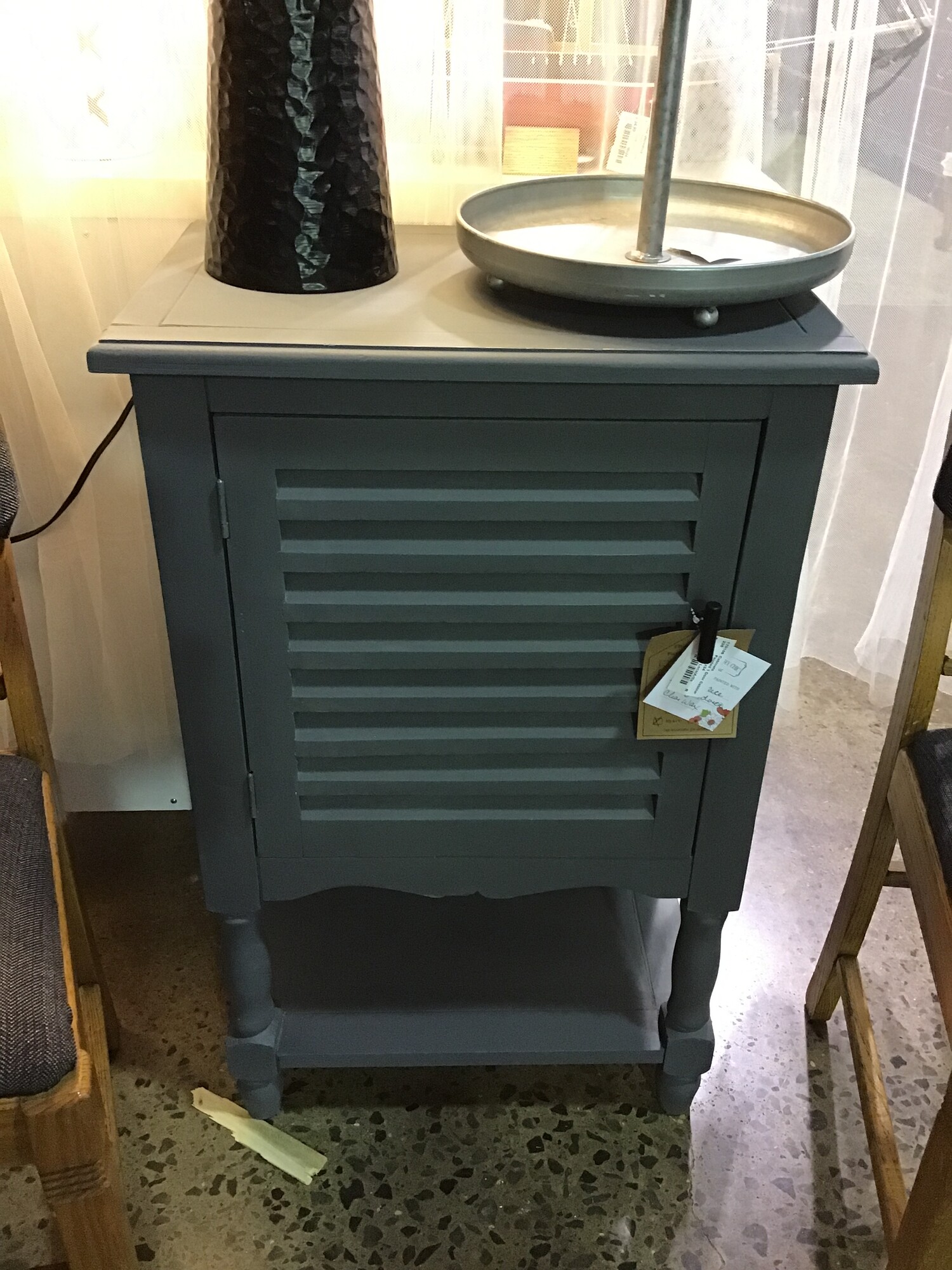 This super functional 1 door cabinet was painted by one of our local artists using a mixture of Country Chic Sage Advice and Liquorice and then clear waxed for protection. It is painted on all 4 sides and features an internal shelf, shutter doors and lower shelf.
Dimensions are 21 in x 14 in x 34 in