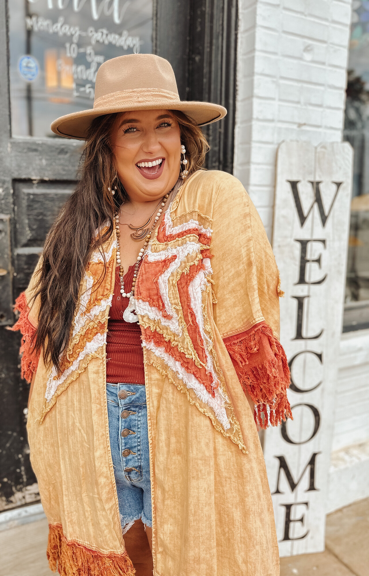 This stunning kimono is high quality and one of a kind! Layers of stitched stars make this piece one that turns heads! The warm tone burnt colors look beautiful with the distressed fringe sleeves!