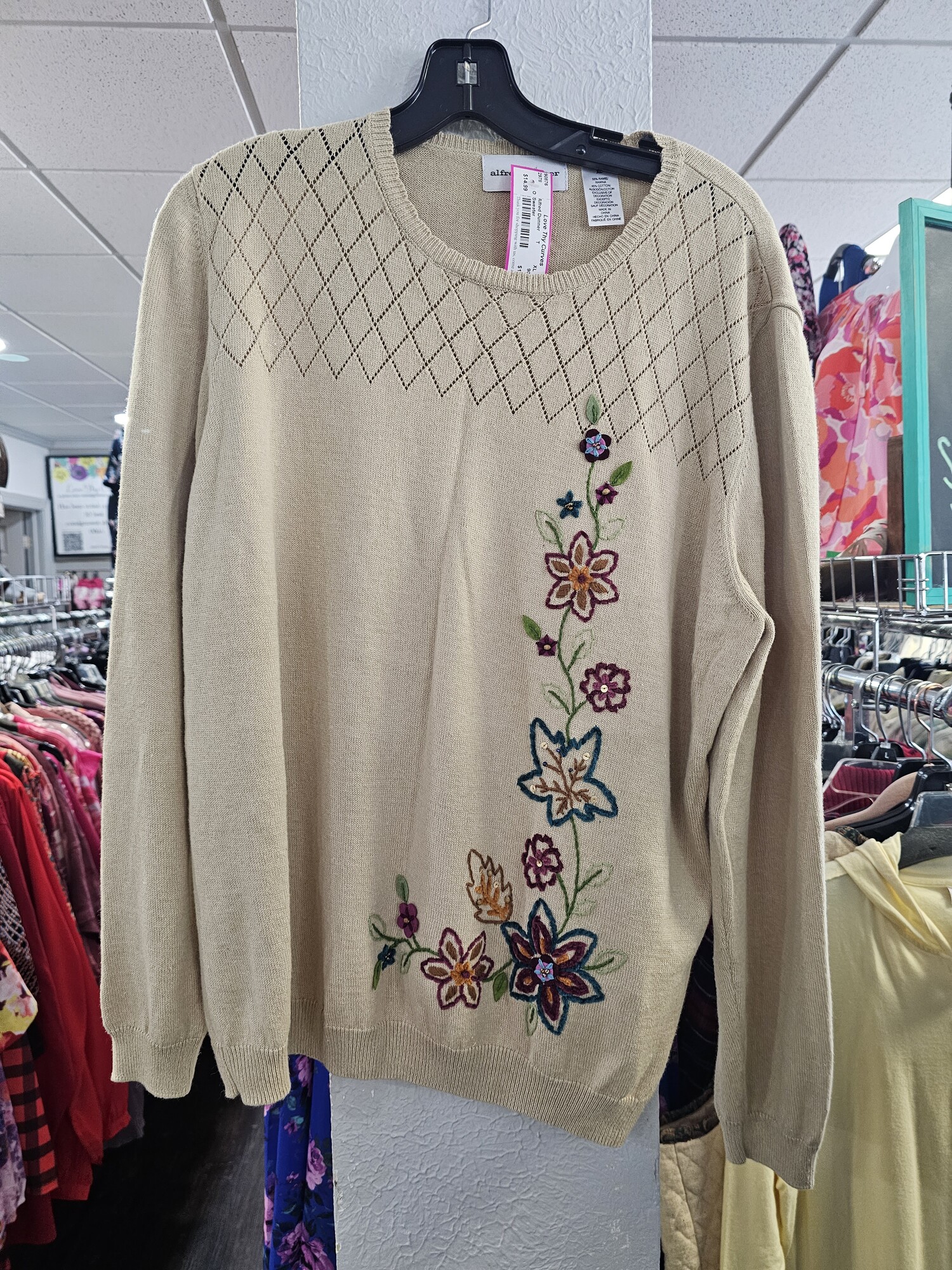 Cute sweater in a soft tan color with cute fall floral design embroidered on the front.