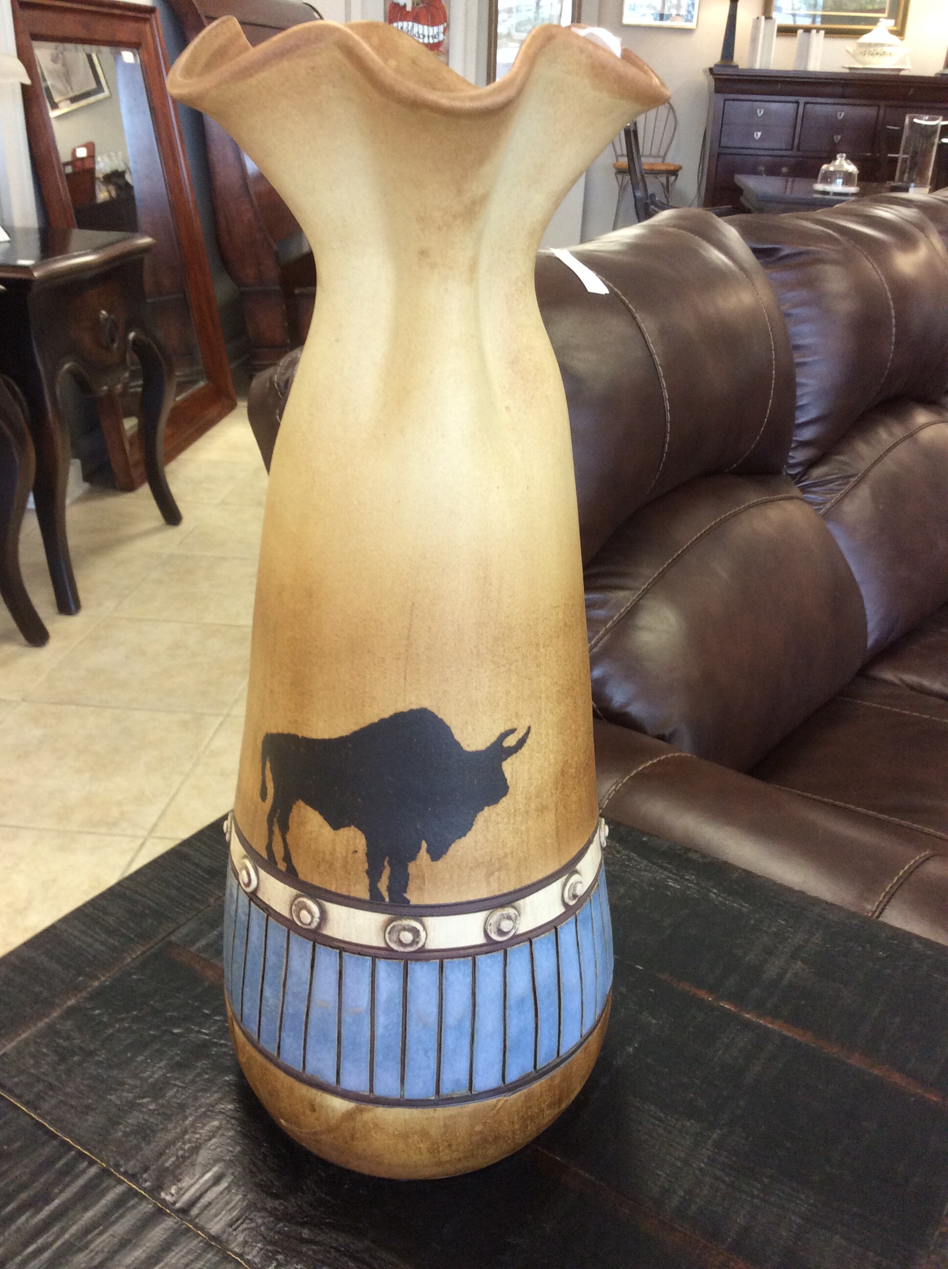 Painted buffalo design with a blue, black, and white pattern around the base of the vase.  This is a nice piece.