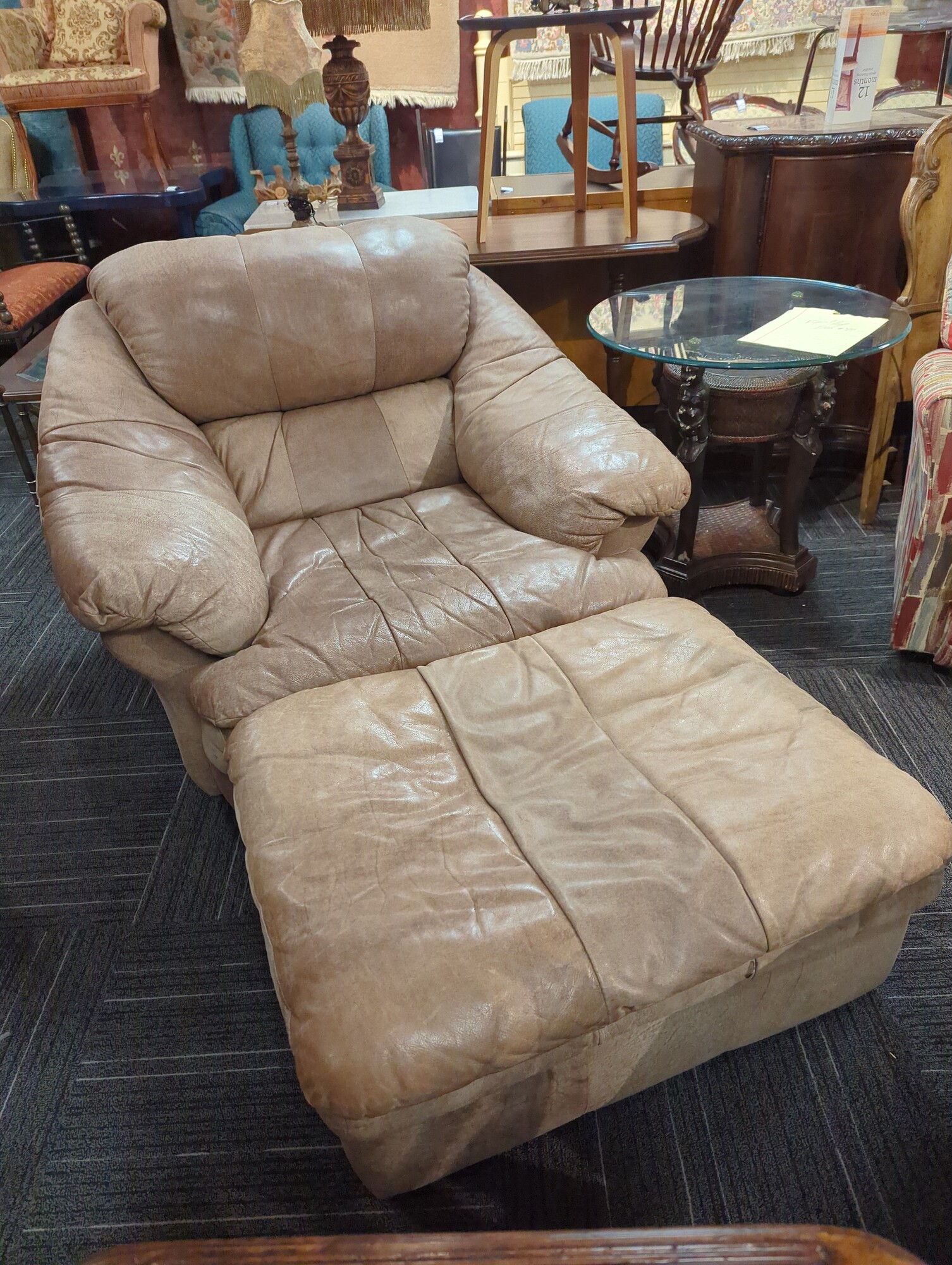 Leather chair with ottoman. Chair is 46in wide ottoman is 35in wide 26in deep.