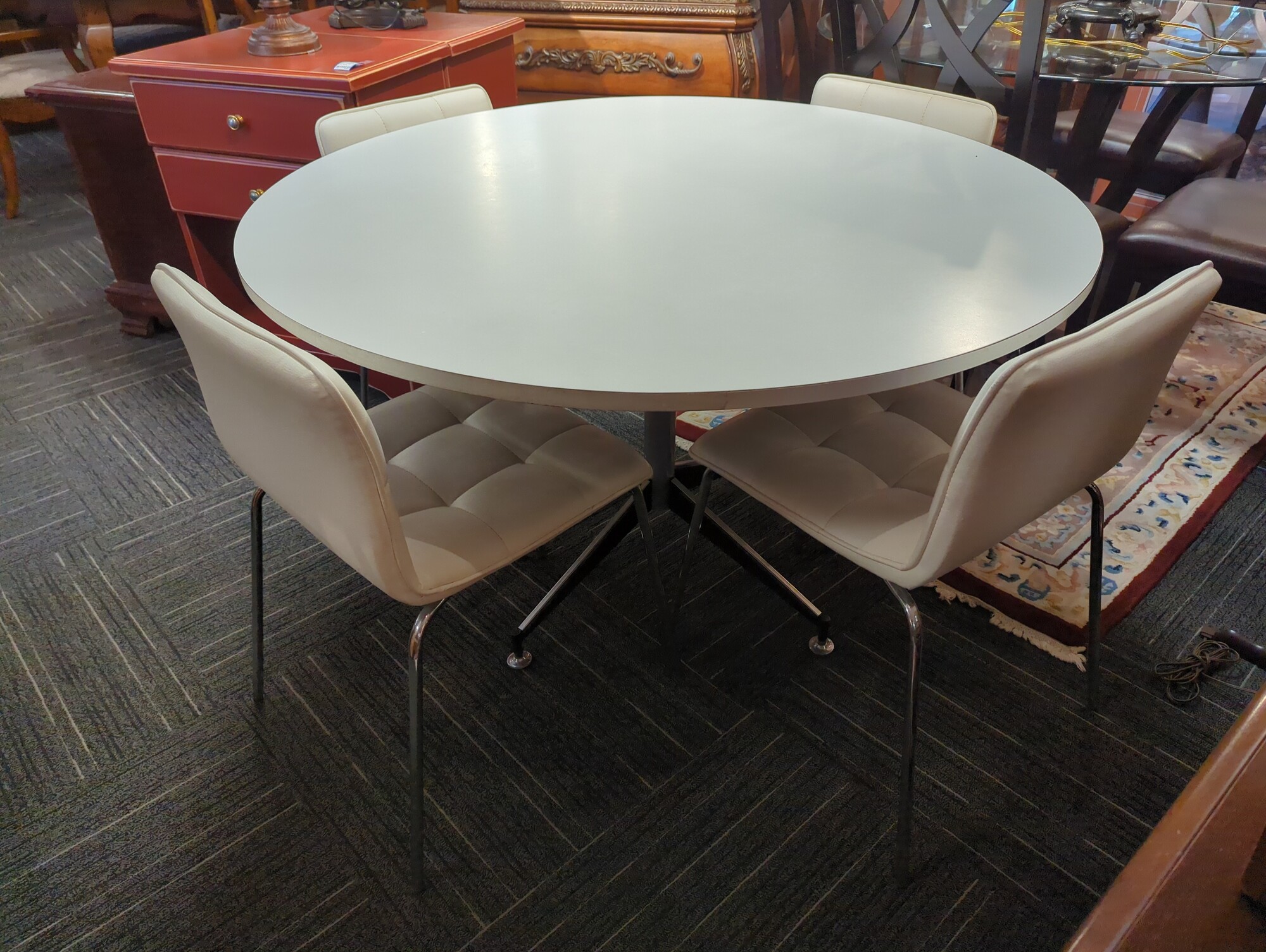 Vintage table with four modern chairs. 48in diameter.