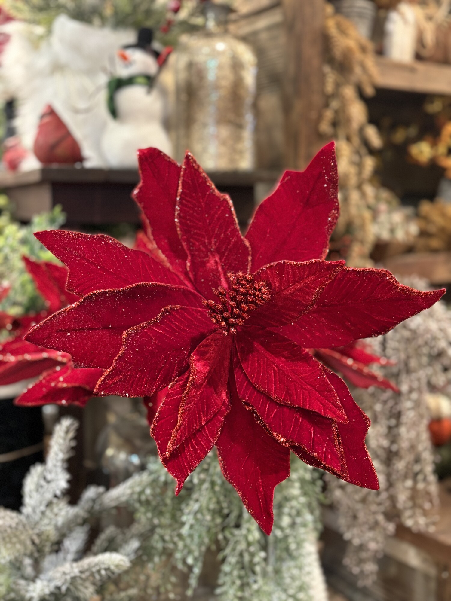 These absoluytely gorgeous red velvet poinsetta stems have just a touch of glitter around the leaves and in the center. They measure almost 14 inches in diameter and are 22 inches tall.  Thye would be beautiful added to your christmas floral arrangement or tucked into your tree
They also fold up for easy storage