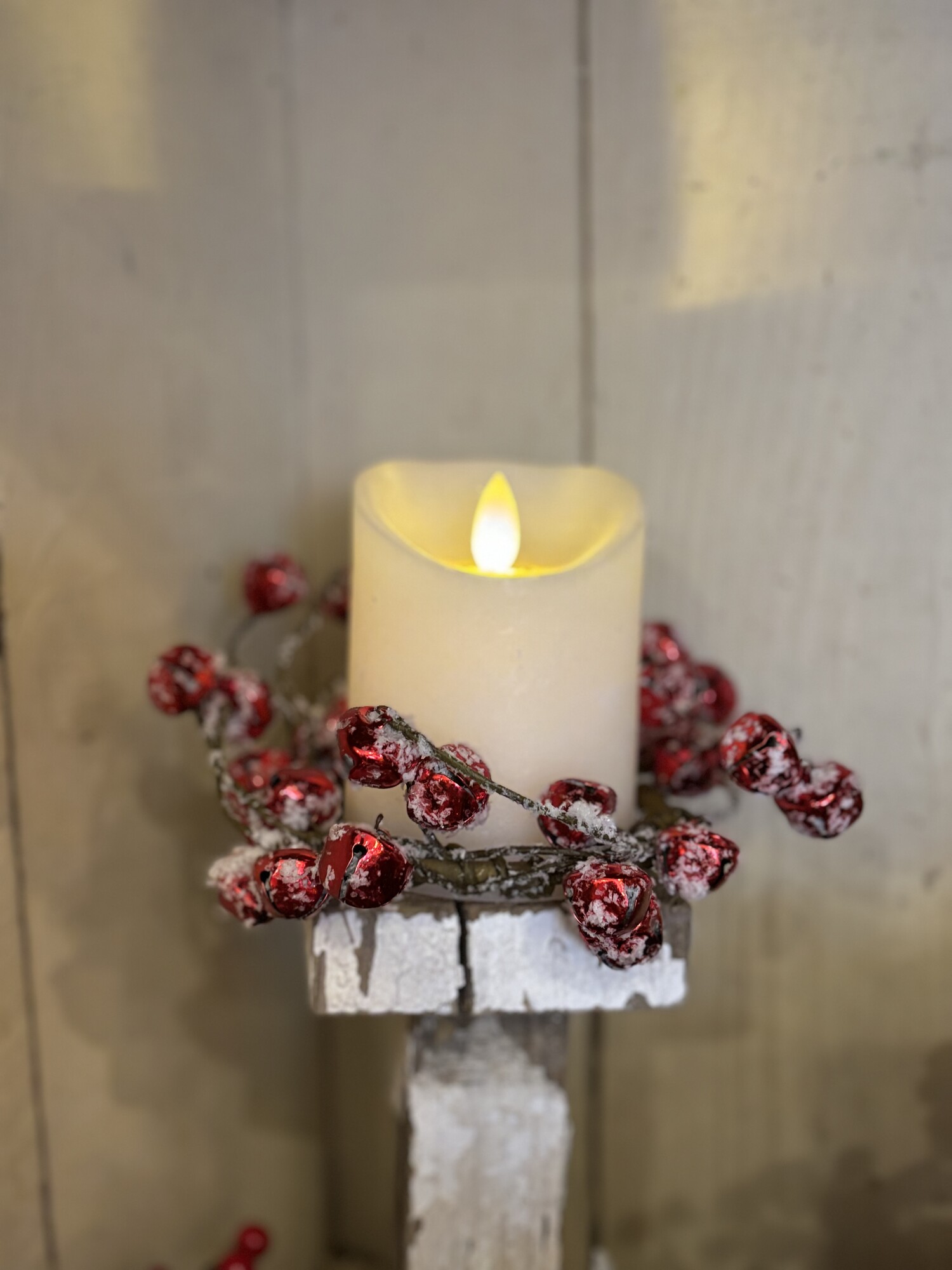 The snowy red jingle bell candle ring has a natural wrapped brown base and has clusters of shiney red jingle bells with thick white flocking for a fresh snowfall effect.  Measures 3.5 inches inner diameter and approx 6-8 inches outer