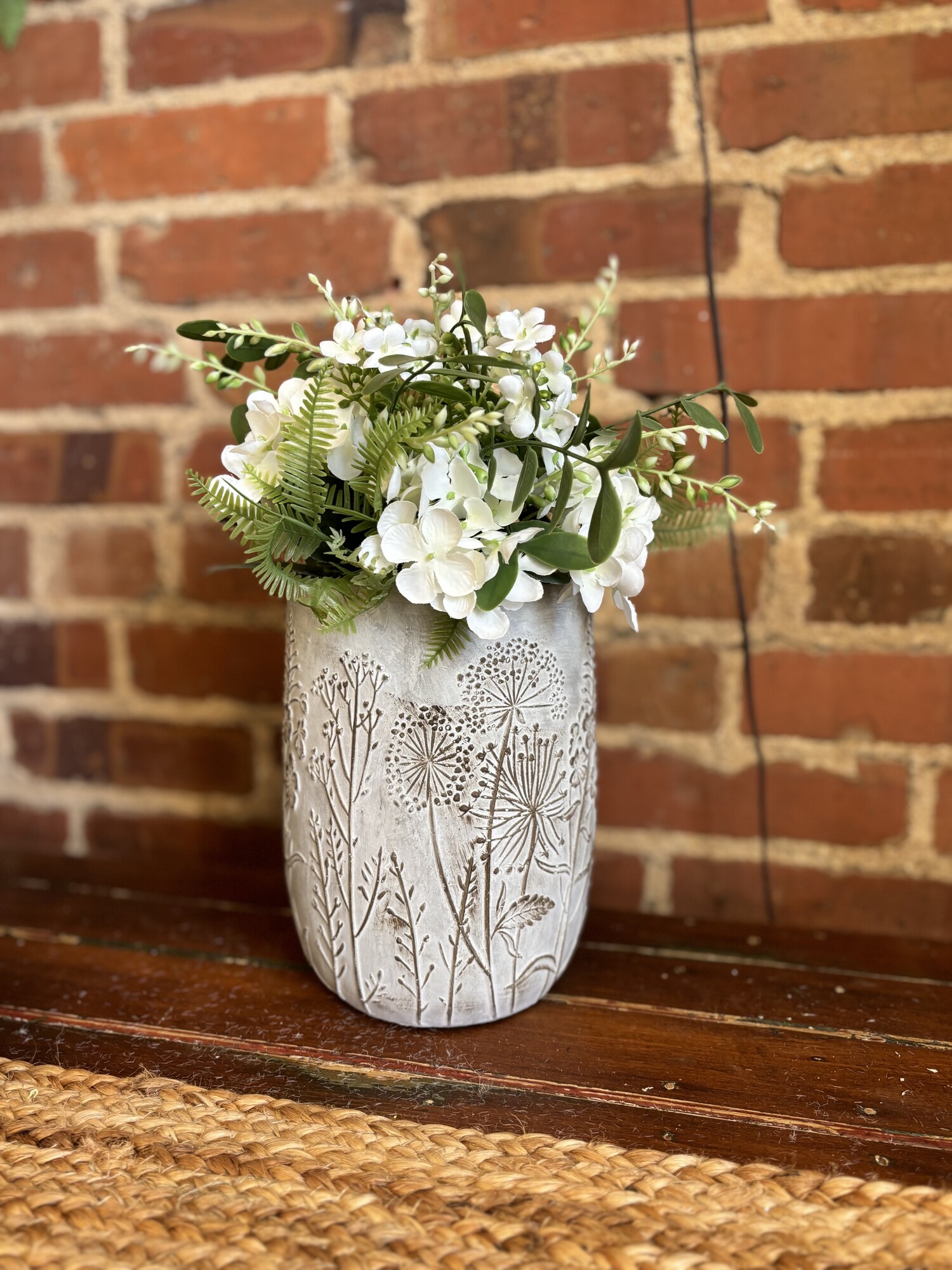 This pretty cement pot has raised lightly painted leaves, flowers and dandelions
This pot is perfect  for any color floral for a touch of spring to your home
Pot measures 8 inches tall, 6 inches width and 7 and a half inches deep