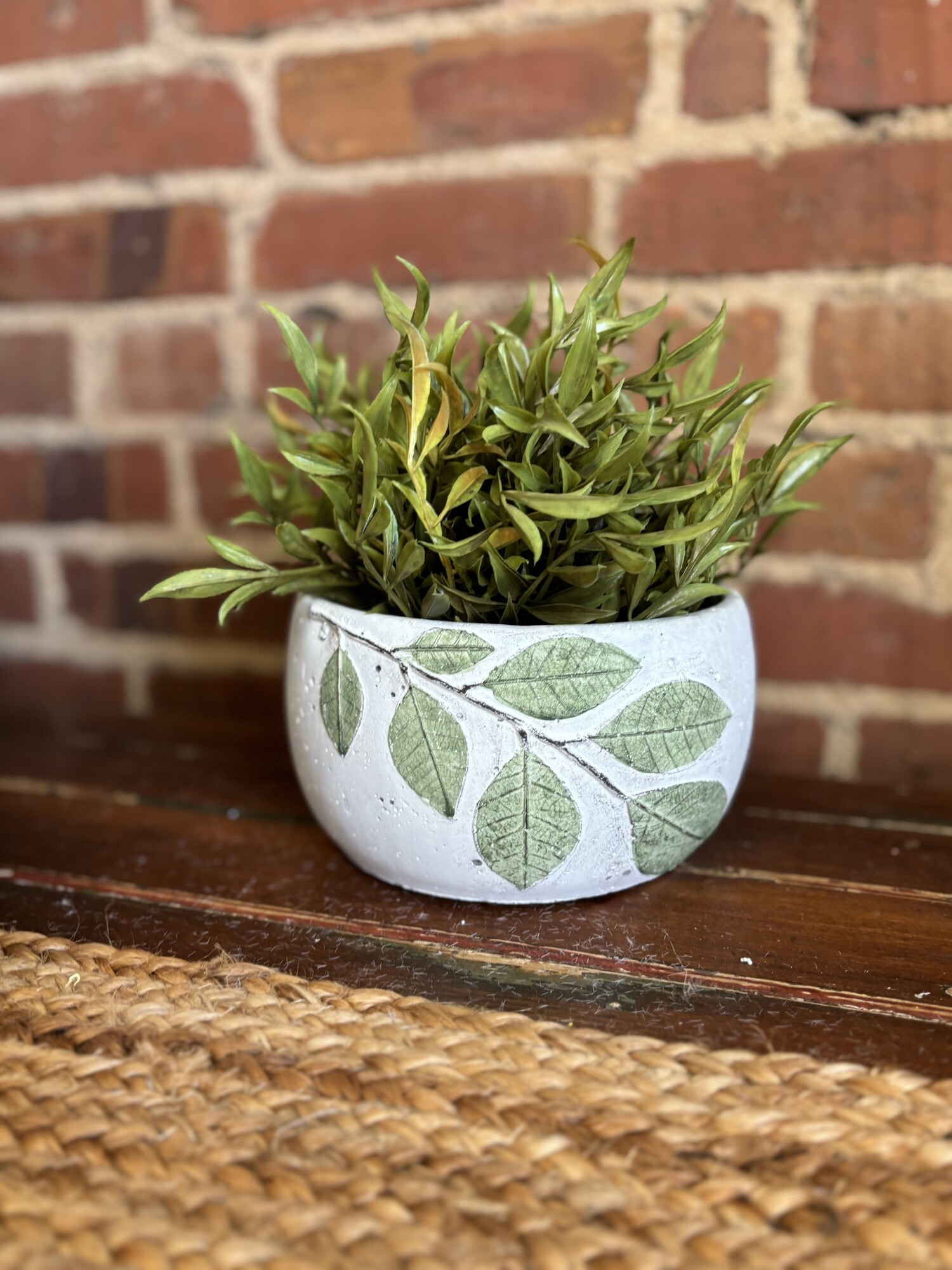 The cement planter with leaves is a pretty pot with raised painted leaves
Pot measures 4 inches high, 6 and a half inches around and is 3 and a half inches deep